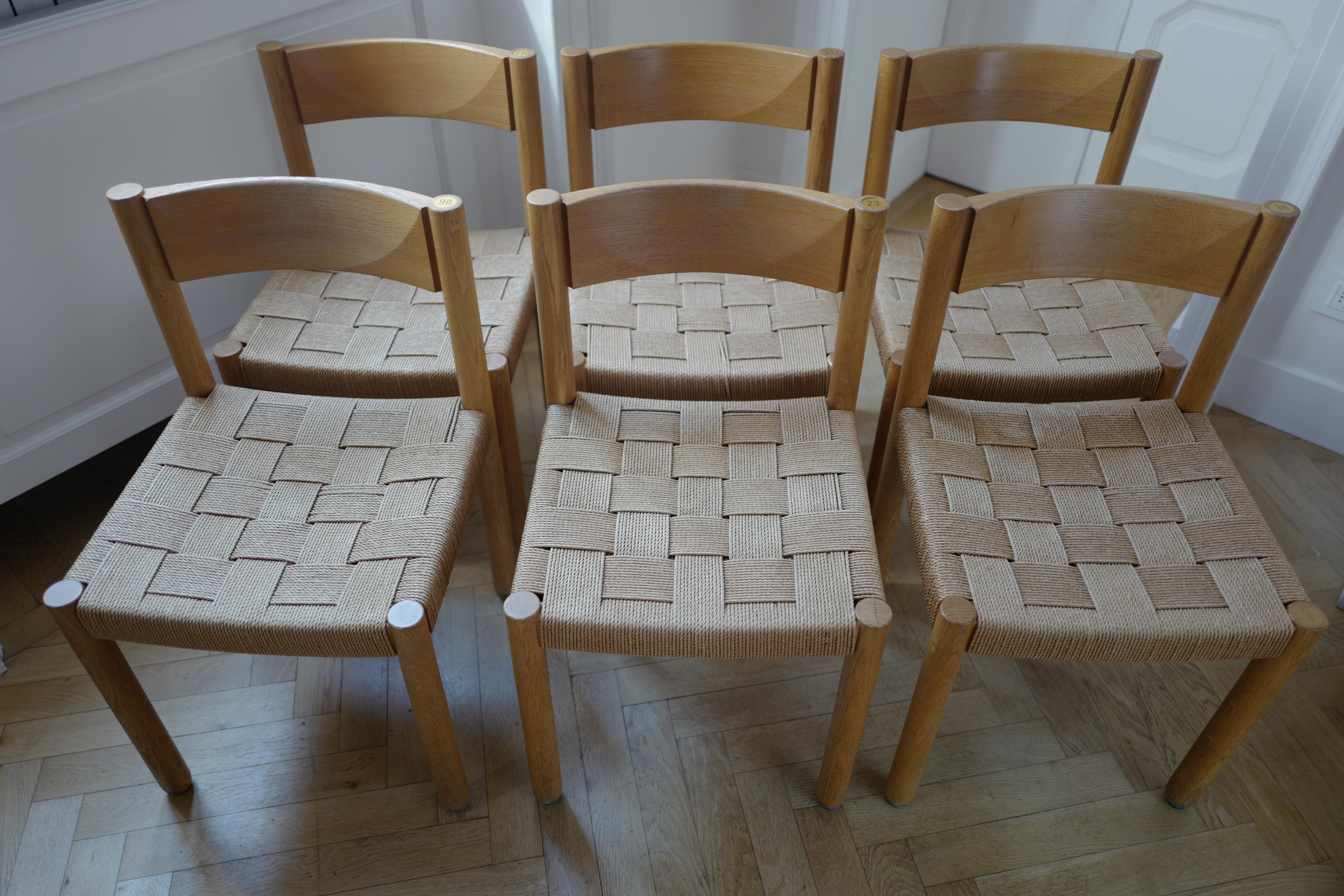 Set of six oak wood and woven rope chairs model 6200 by Robert and Trix Haussmann from Zurich Switzerland. These married architects did not gain as much fame as their Milanese counterparts in America but in Europe they are a postmodern sensation. A