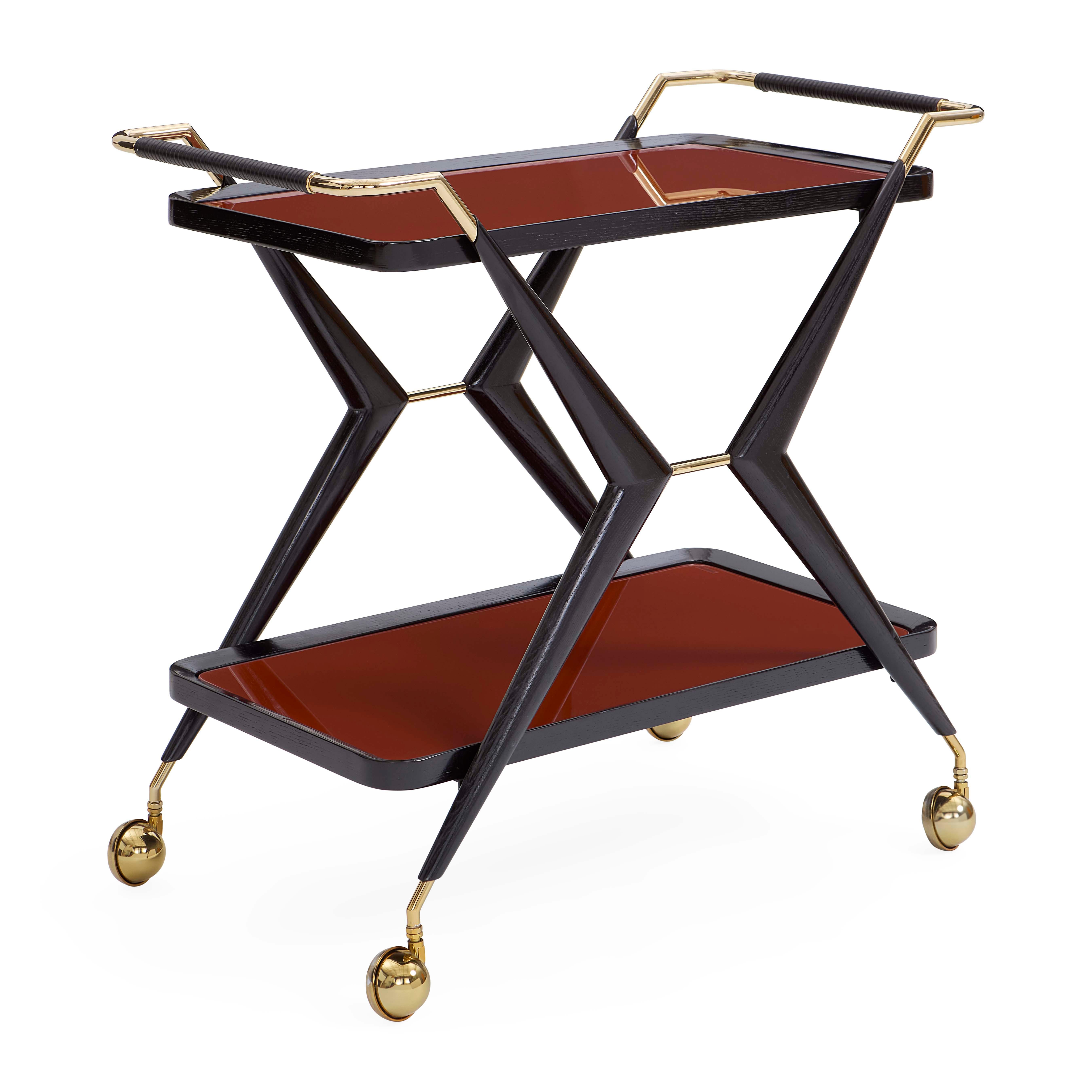 Mad Dramatique.

A sculptural ebonized wire-brushed oak frame, leather-wrapped modern brass handles, and wheeled feet with polished brass casters—our Trocadero Bar Cart has it all. Featuring two glass shelves back painted with our moody cinnabar