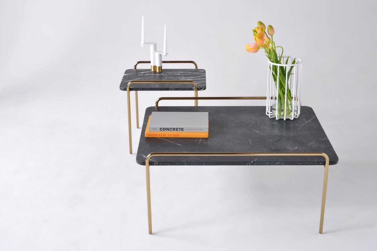 The Trolley Coffee and Side tables exemplify purpose and purity. Sharing design cues from the other members of the Trolley family, a rounded marble top surface rests deliberately on top of a steel frame with integrated handles. These tables ride the