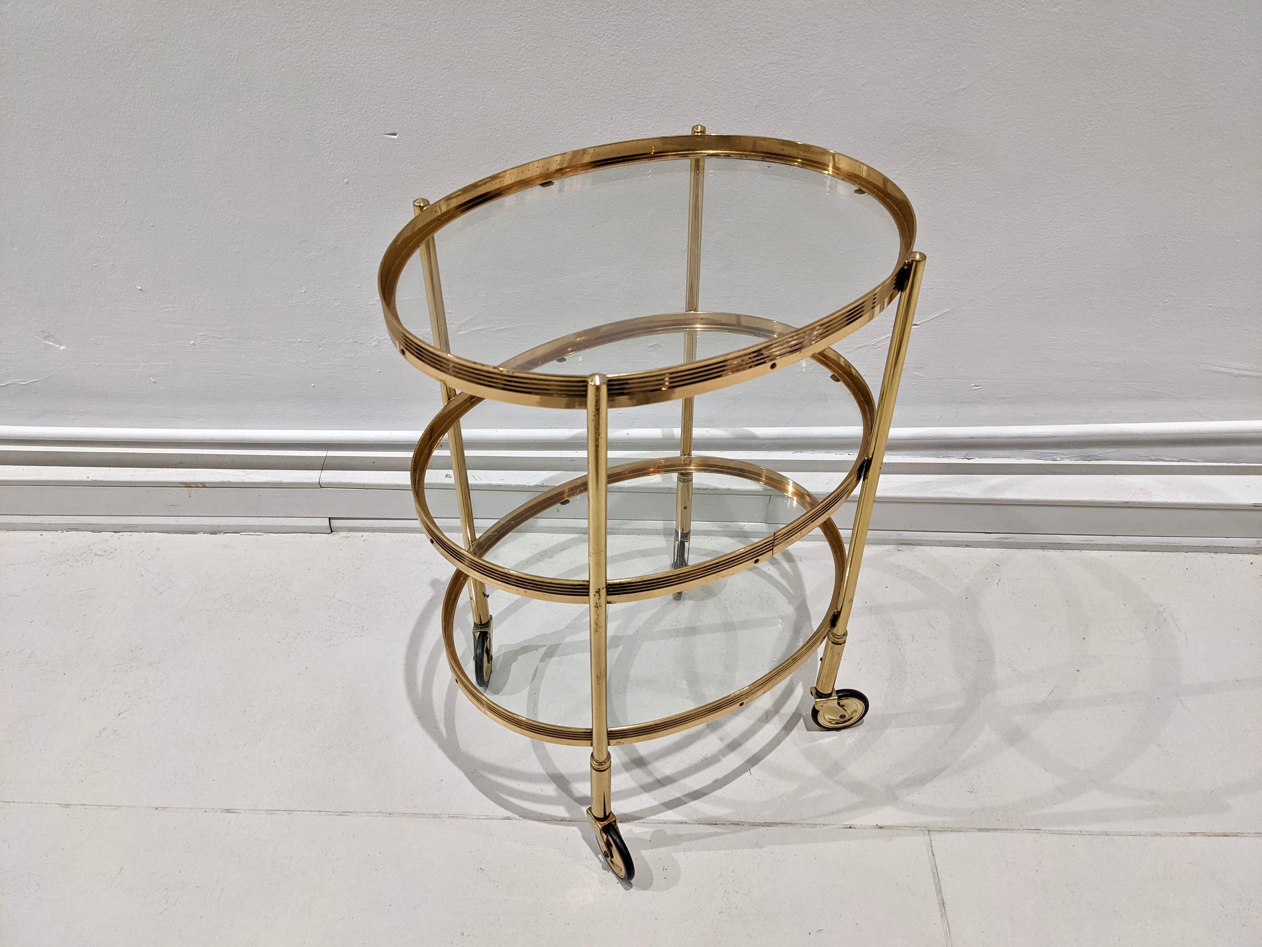 Trolley in brass gold color. Glass tops. Maison Jansen, 1960s. Very good condition.
  