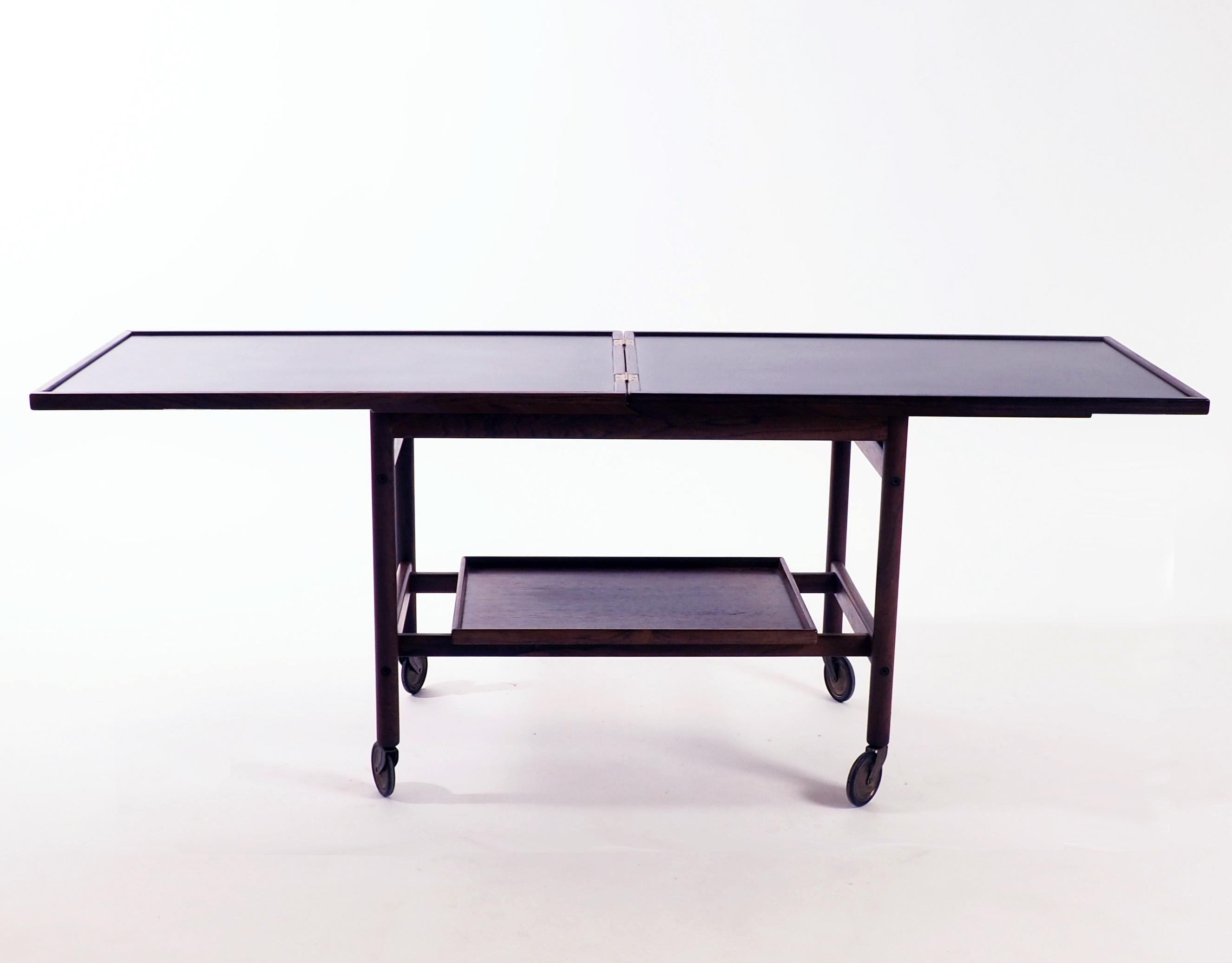 Trolley in rosewood and Formica by Kurt Östervig. Produced by Jason, Denmark. The top folds over and slides for extending to double size.