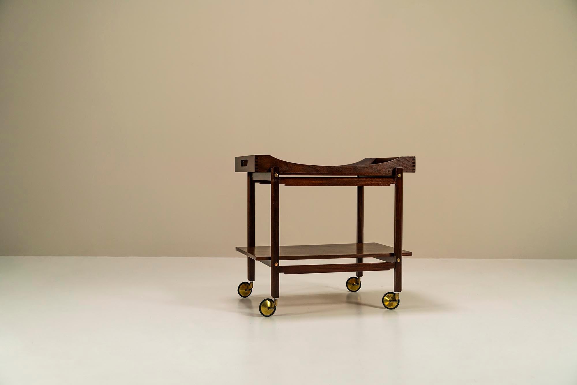 Trolley in solid wood finished with mahogany veneer.The practical function of the trolley, also called a serving trolley, is something from a bygone era, but the object itself has again won the hearts of the vintage design-loving public in recent