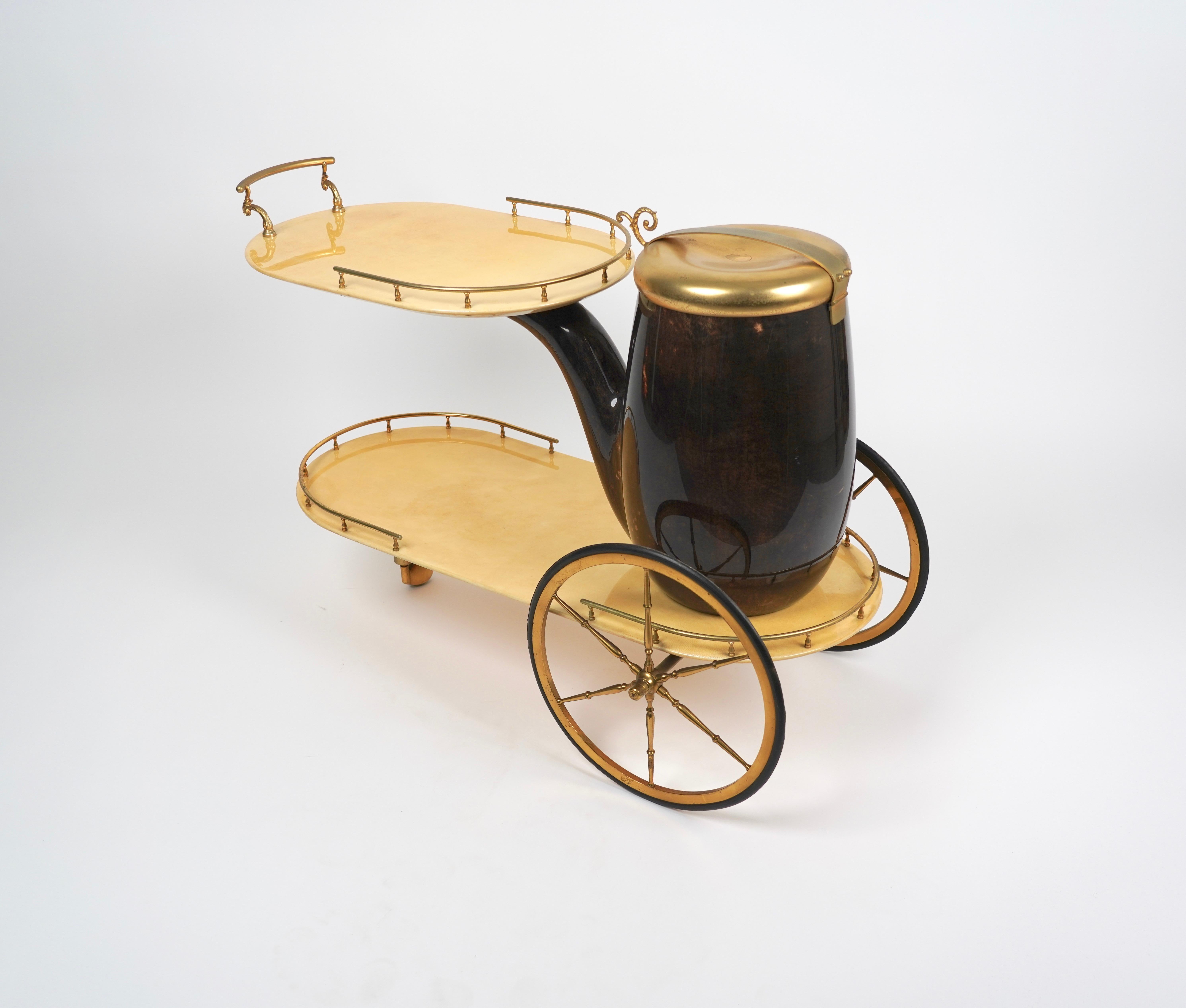 Aldo Tura design lacquered goatskin and brass bar cart trolley with 2 tiers, a pipe-shaped ice receptacle, and beautiful brass mounts. Made in Italy, circa 1960s.

One of the most enigmatic and polarizing figures to emerge in Italian design, Aldo