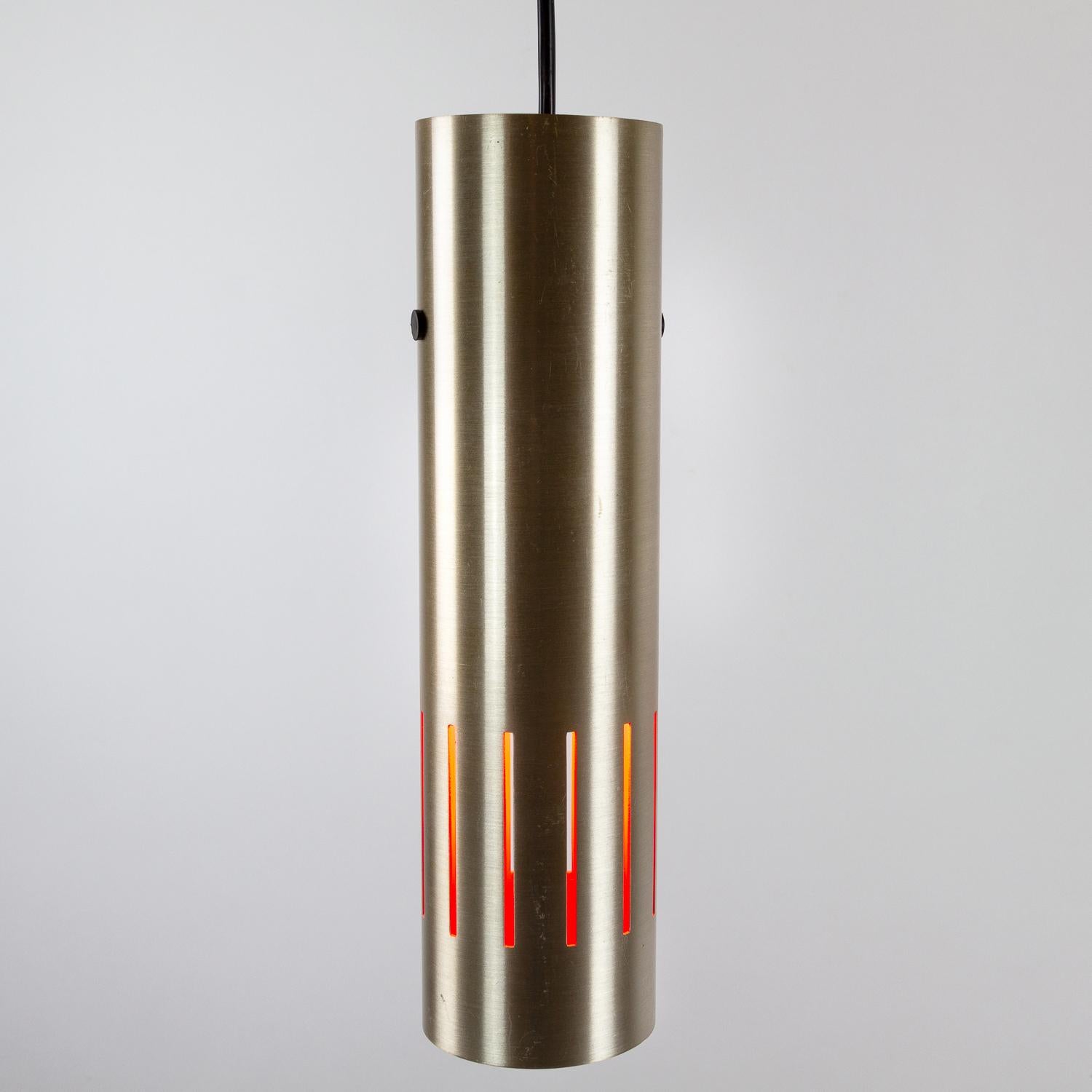 A Jo Hammerborg Trombone pendant in brass with orange interior. Designed in 1968 and produced by Fog & Mørup, Denmark. Patina as expected.

 