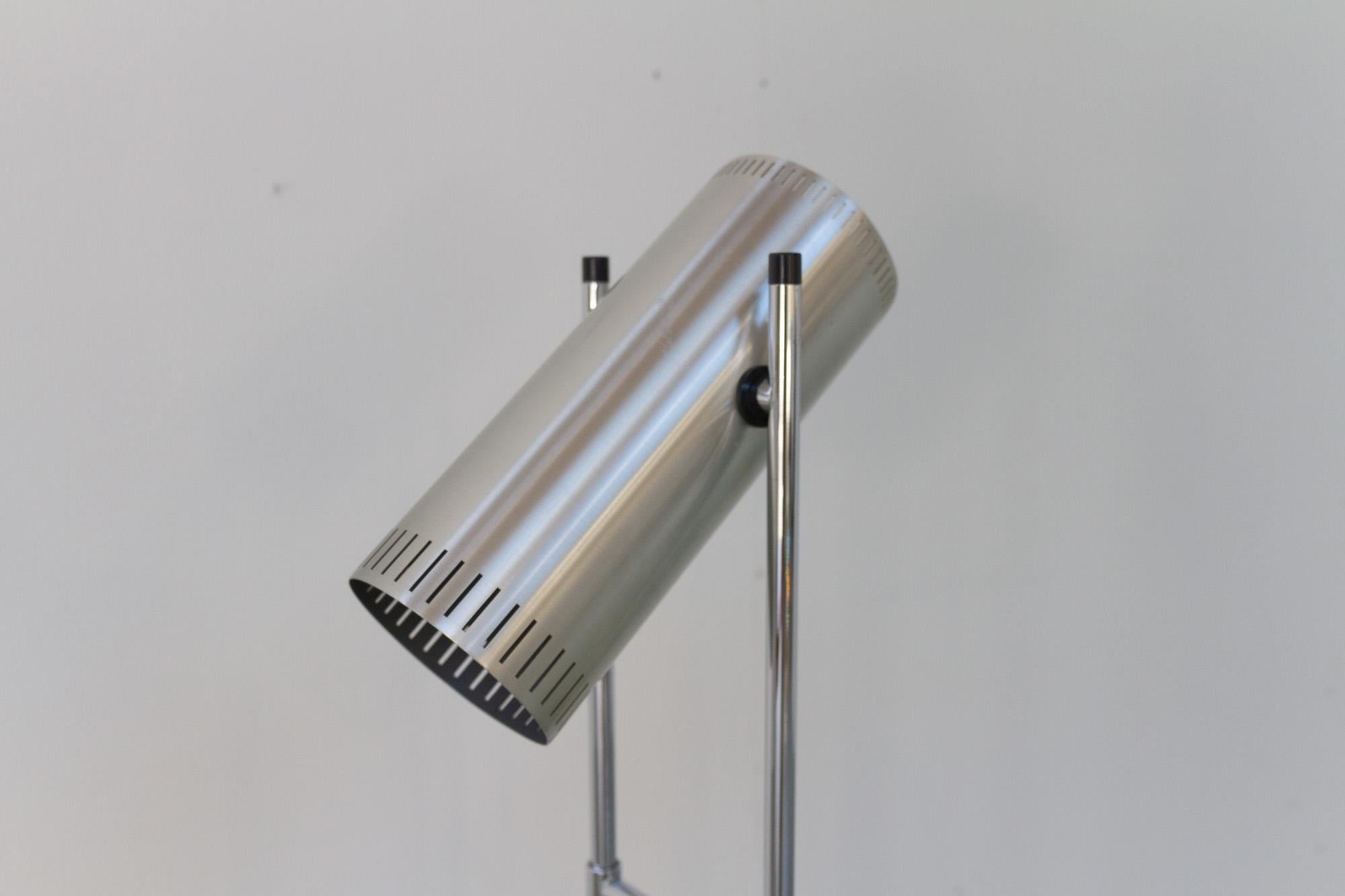 Trombone floor lamp by Jo Hammerborg for Fog & Mørup, 1960s.
Danish Mid-Century Modern tall floor lamp in lacquered aluminium and chrome. Cylindrical head with row of slits along bottom and top. Switch on top. Angel of head is adjustable. Two