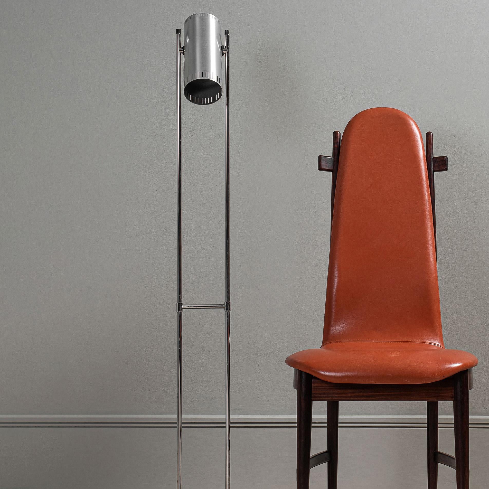 The classic midcentury Trombone II floor lamp designed by Jo Hammerborg for Fog and Morup, Denmark, 1966. 
Strict modernist lines of chrome and aluminium with angle adjustable cylinder head. On/off button is located in the top of the cylinder head.