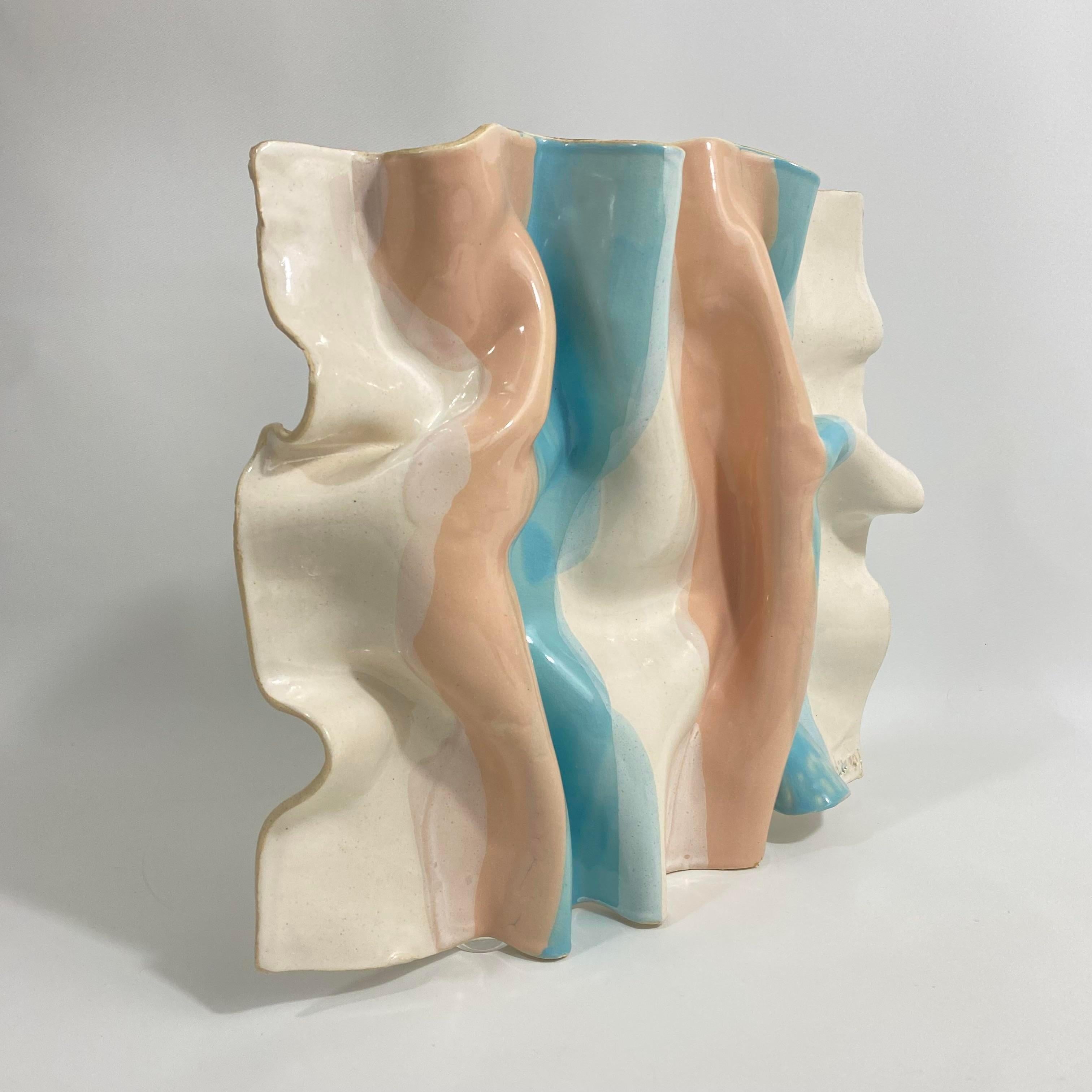 Vintage circa 1980s Barbara Demery trompe l'oeil ceramic wall sculpture resembling a piece of gathered striped fabric. Stripes are peach and blue with a oatmeal colored background. This piece has a mounting hole or can actually be laid flat to be