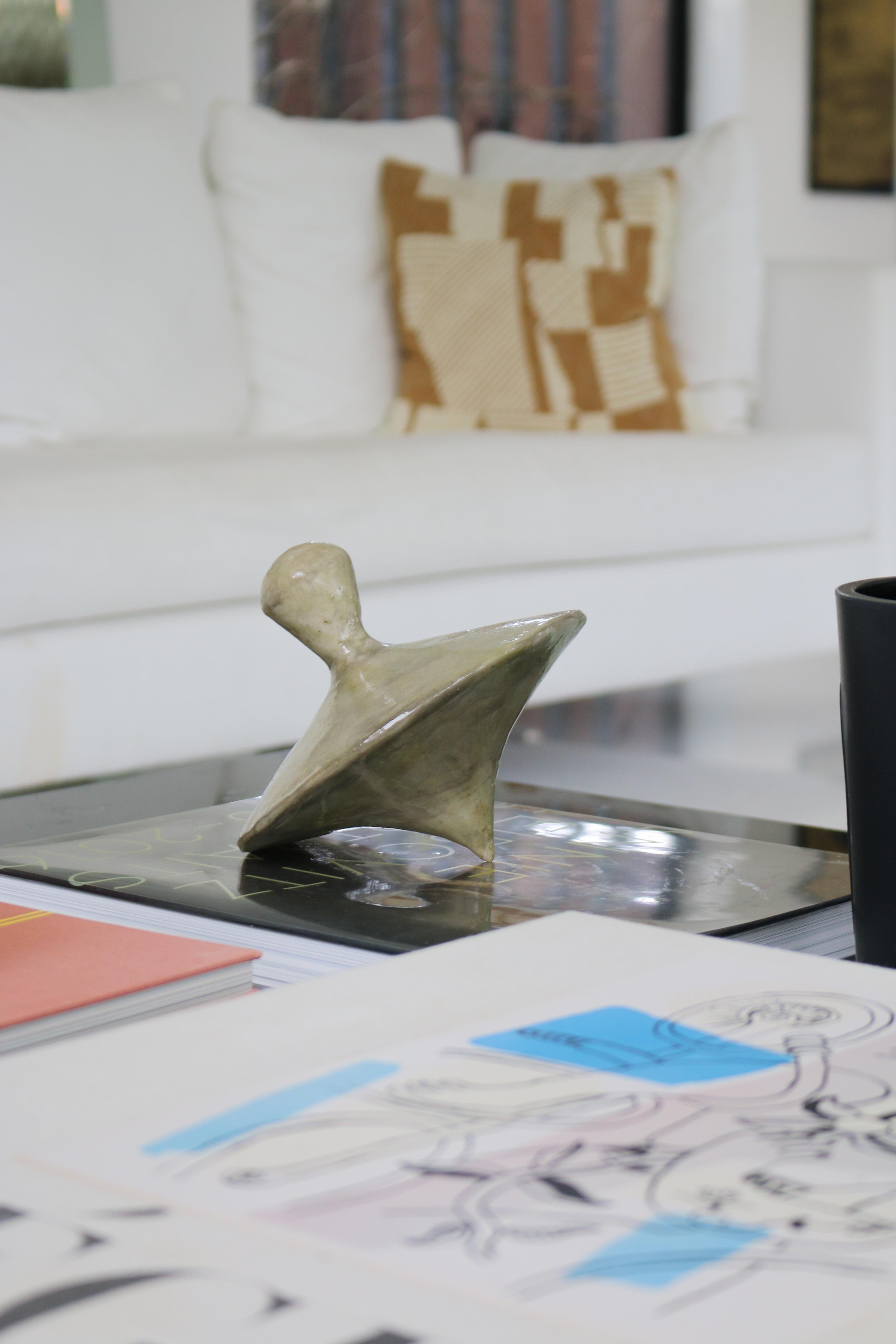 Spin into style with our 'Trompos' Uno! Meticulously hand-sculpted and hand-cast by skilled artisans from a unique blend of resin and stone composite, these captivating pieces are more than just decor. They add a playful touch to any coffee table or