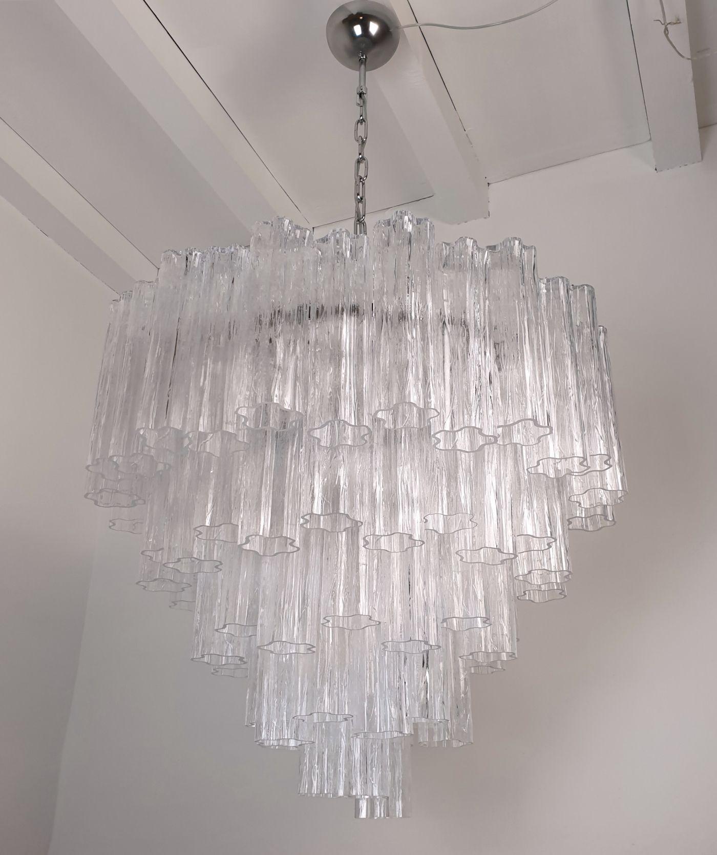 Large Tronchi Murano glass Mid Century Modern chandelier, created by Toni Zuccheri for Venini, Italy 1980s.
The chandelier has a nickel frame, with 7 lights.
Rewired for the US with Medium base bulbs sockets, or E26. (you can use LED ones)
The