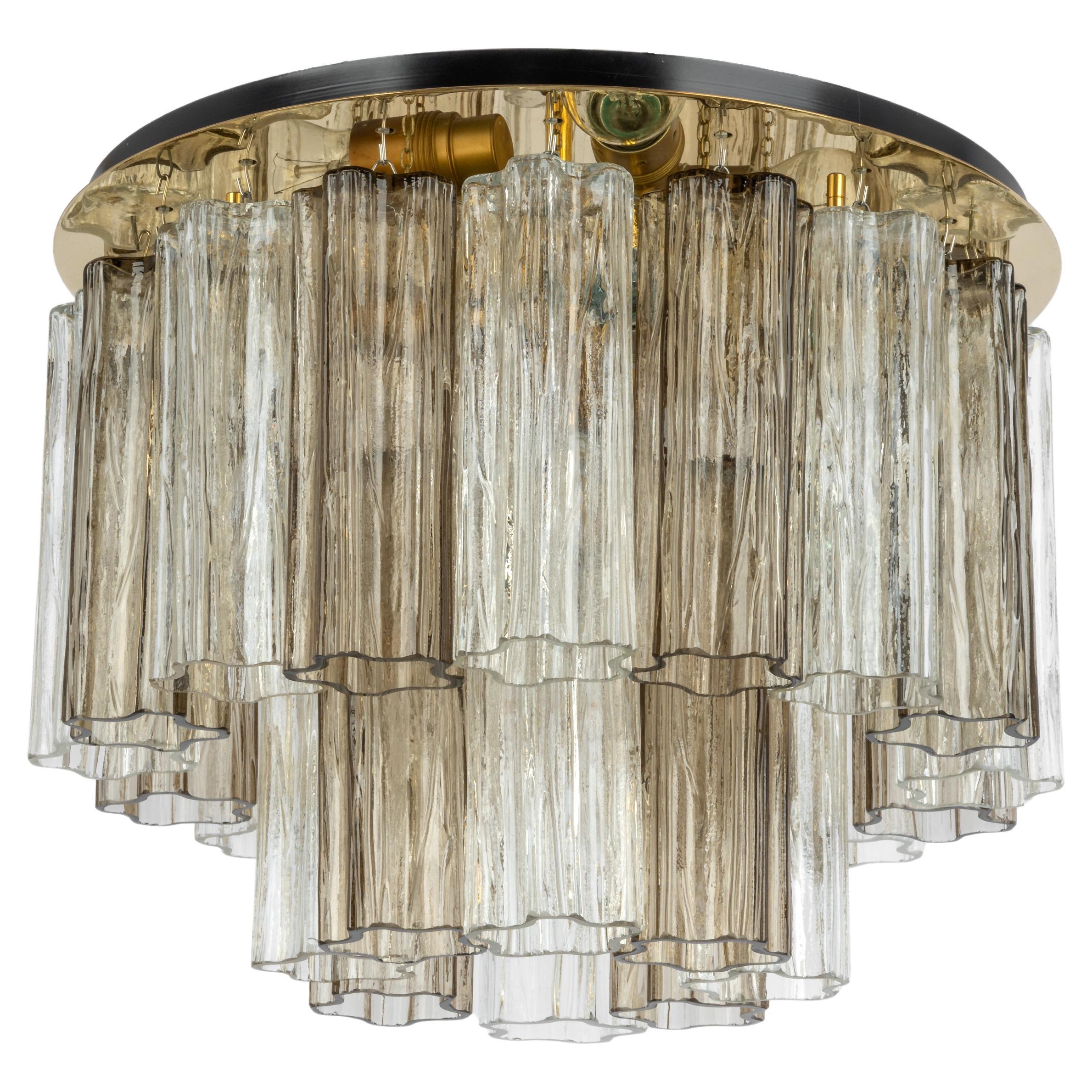 Stunning Murano glass chandelier designed by Venini for Kalmar, 1960s
Two tiers gather many structured glasses, beautifully refracting the light very heavy quality.

High quality and in very good condition. Cleaned, well-wired and ready to use.
The