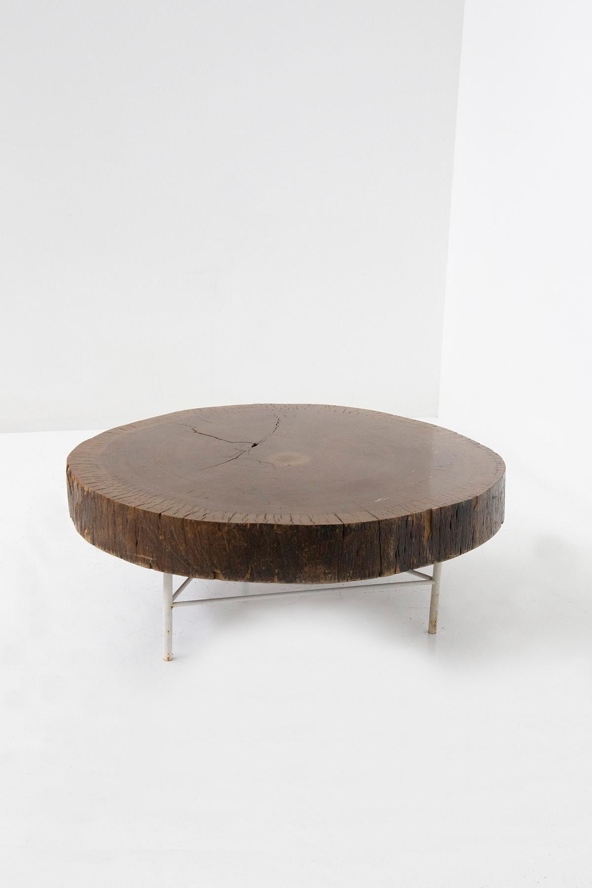 The Tronco coffee table, a masterpiece conceived by visionary Ignazio Gardella, is an astonishing creation that transcends simple furniture. Crafted with an extraordinary passion for design and an unwavering reverence for nature, this magnificent
