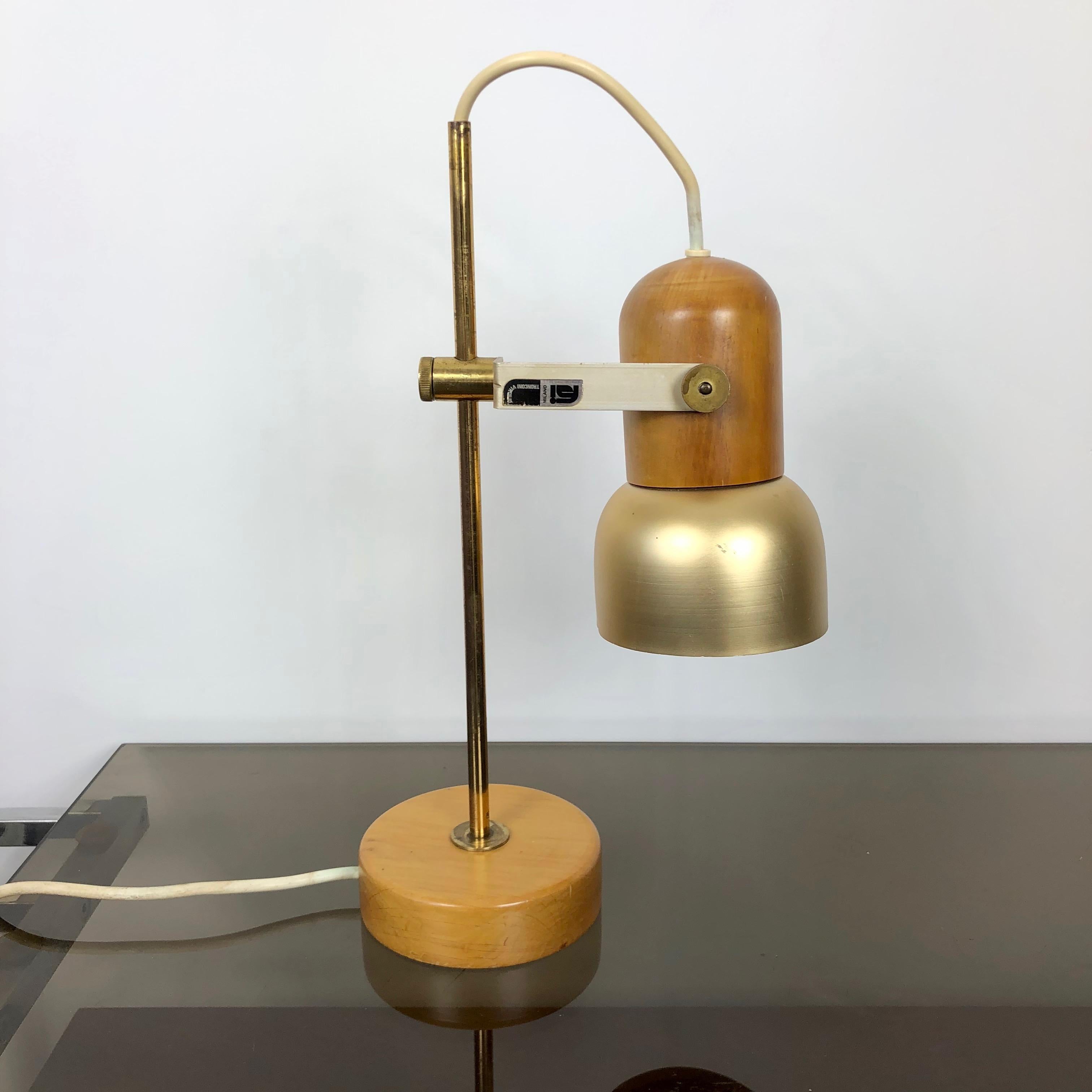 Adjustable table lamp by the Italian designer Virgilio Tronconi for FSI Milano, circa 1970. Made in wood, brass and metal. Conditions are very good, the brass, due to its age, is a bit ruined, as the photos show. 

The original label is still on