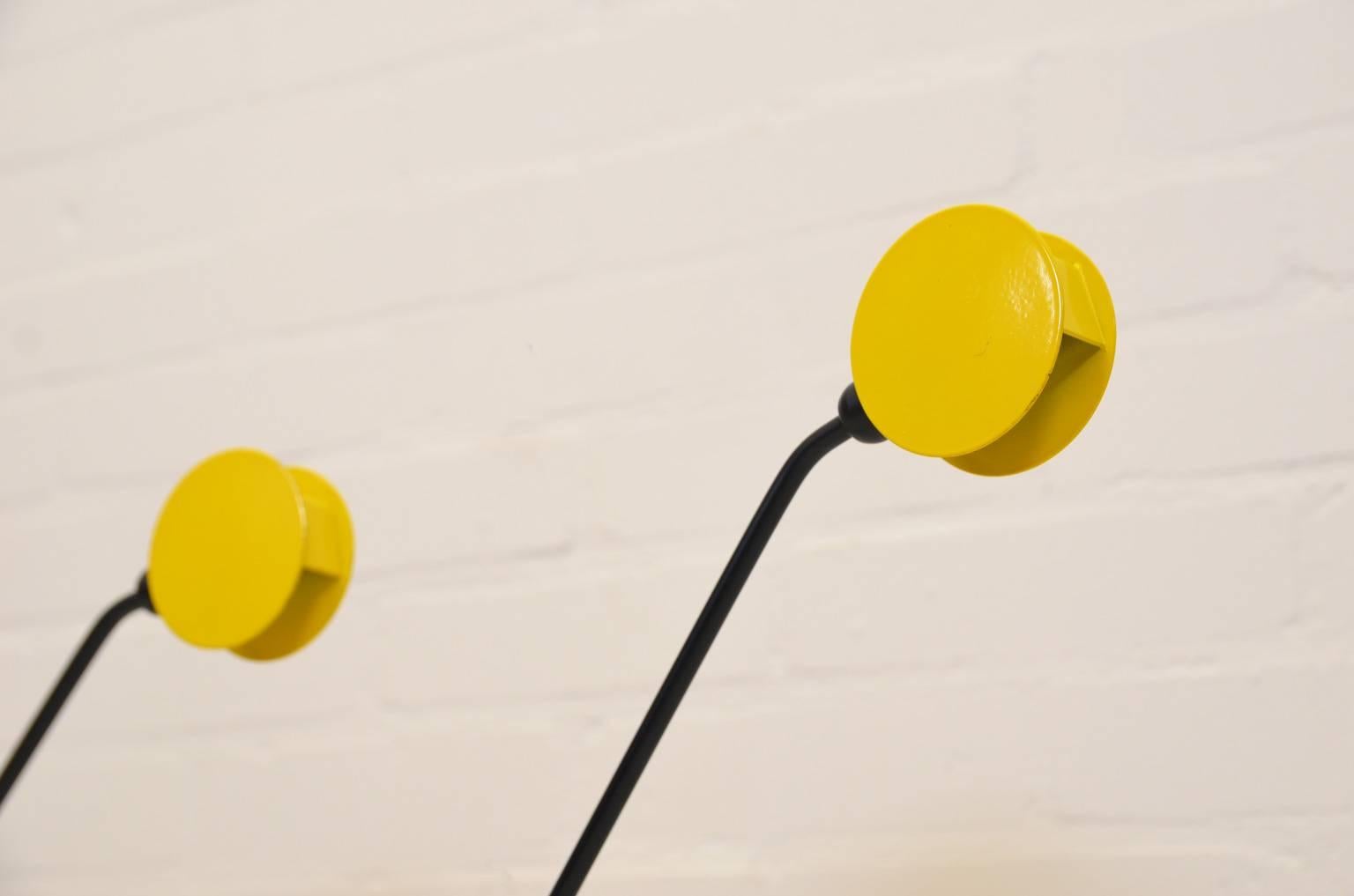 Black lacquered table lamp with yellow adjustable hood.