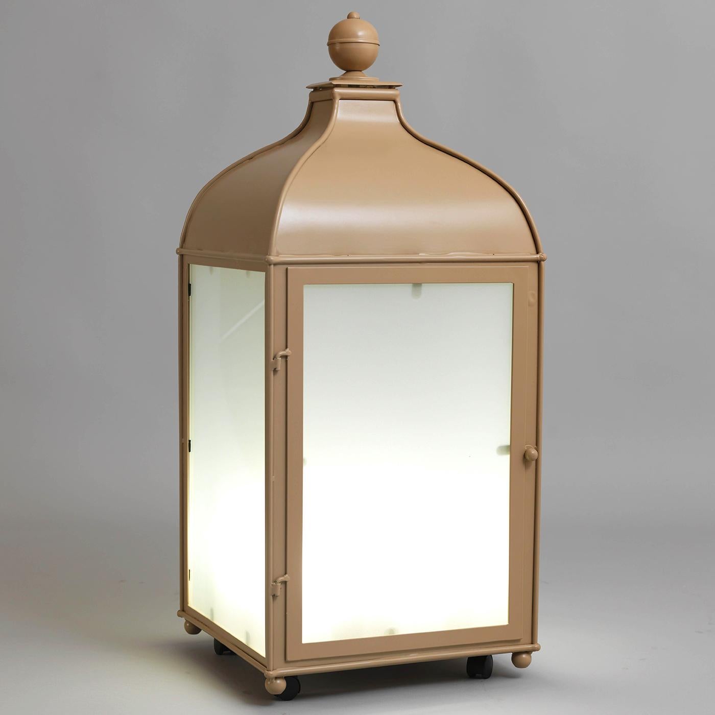 This elegant lantern boasts a stately yet timeless design that will make it a bold addition to an outdoor party by the pool or a family dinner on a terrace or patio. The stainless steel structure features a Minimalist silhouette topped with a domed