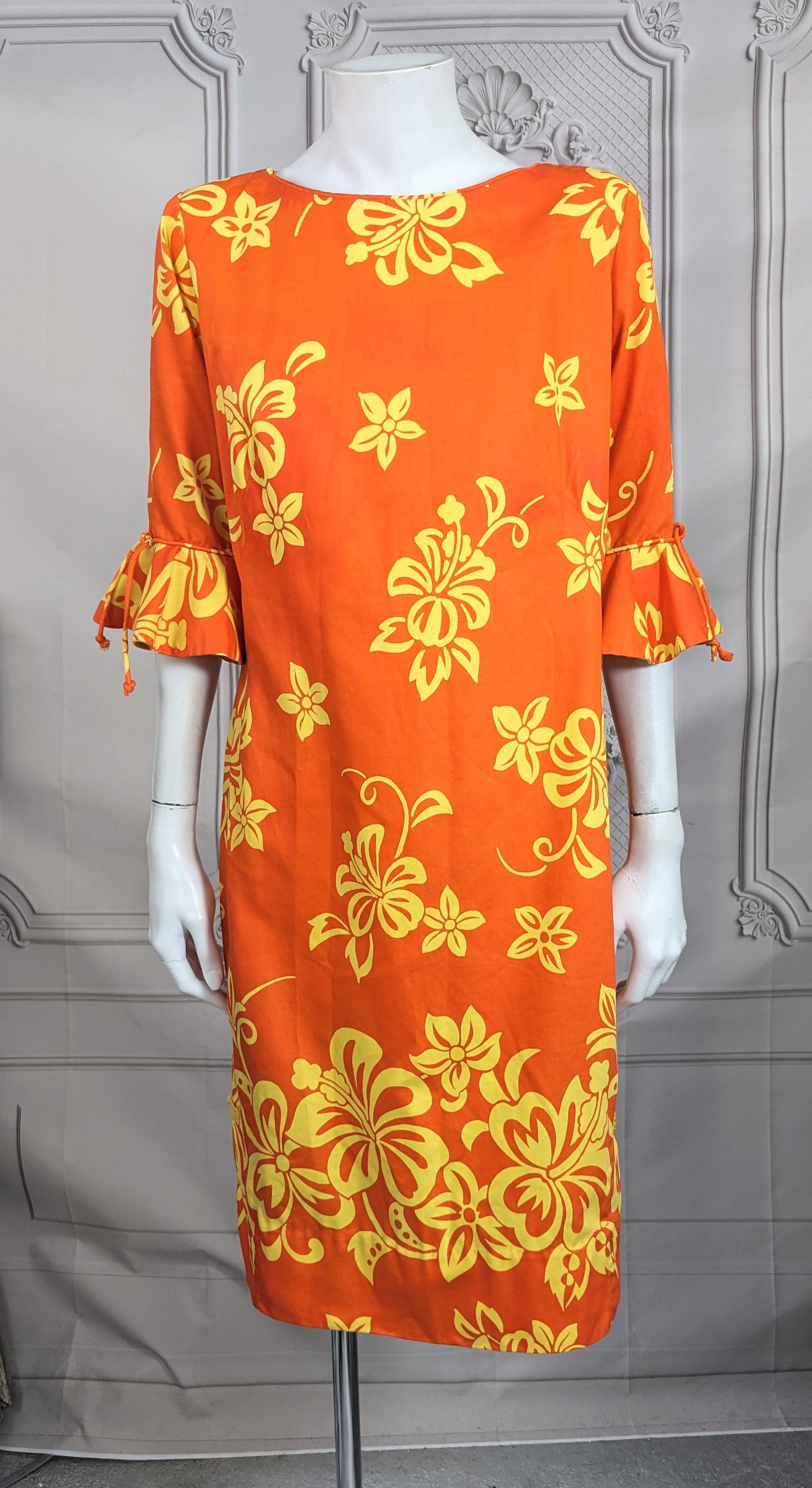 Charming Tropical Print Mid Century Sheath in polished cotton from the 1960's. Yellow florals on orange ground. Simple straight cut with 3/4 sleeves with flounces with Chinese knot detail at side slits. Back zip entry, retailed at Lord and Taylor.