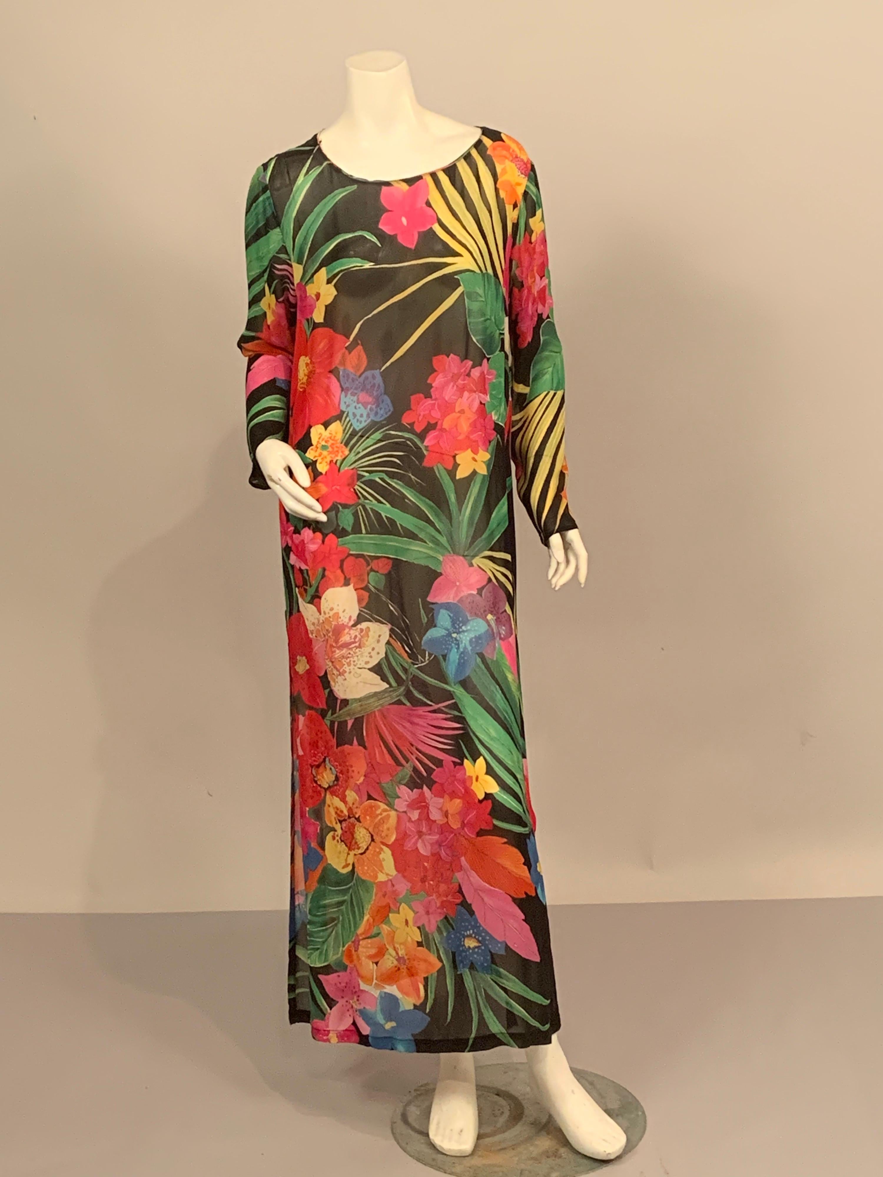 Start planning your Island vacation now because this is your perfect dress or caftan.  The sheer black background allows the brilliant tropical blooms to be so eye catching.  Shades of pink, red, orange, yellow, blue purple and green just pop