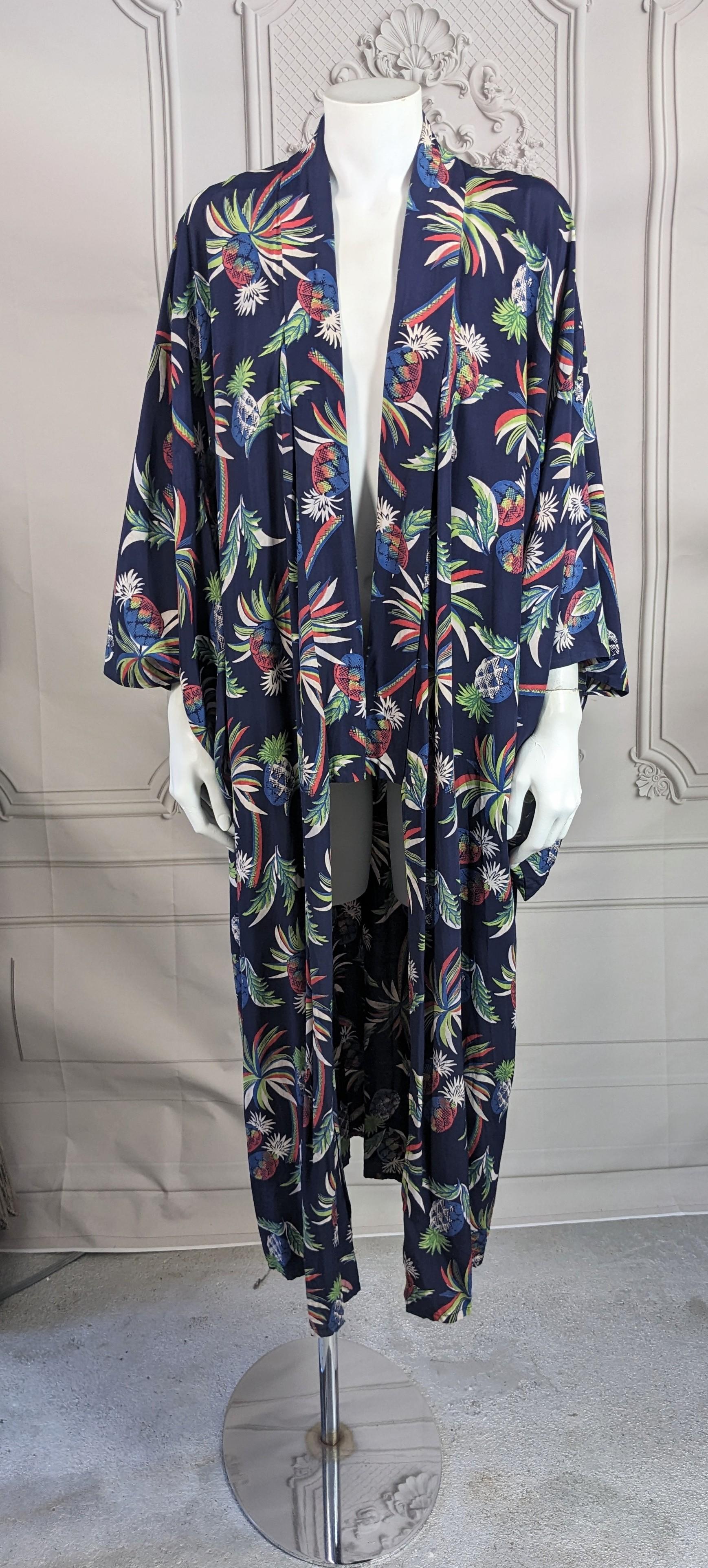 Rayon 1940s kimono printed with wonderful  tropical flowering pineapples and leafy fronds, in whites, reds and greens on a navy blue ground with self attached belt. Classic kimono shape made for export. Very Good  condition. 1940's Japan made for