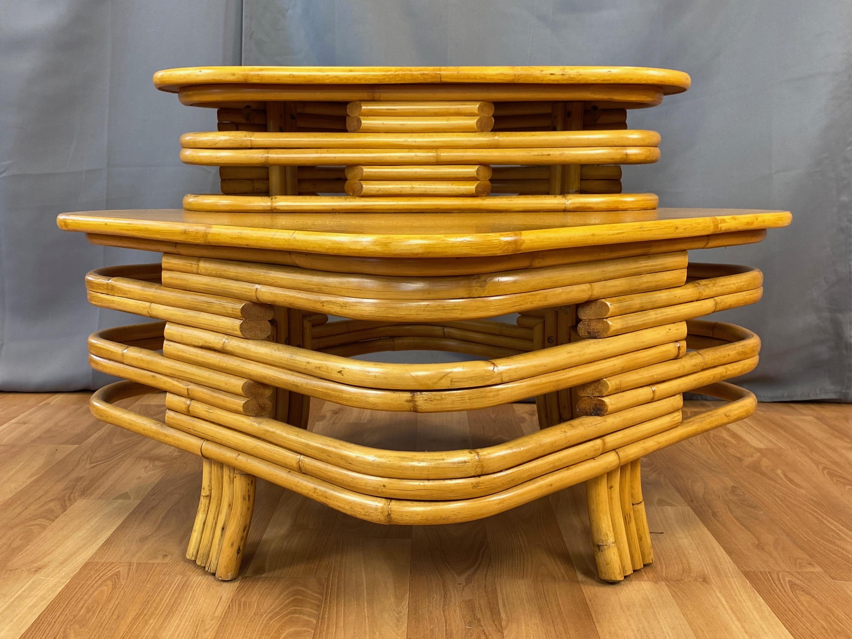 A very handsome mid-century Paul Frankl-style rattan and mahogany two-tier corner table by Tropical Sun Co. of Pasadena, California.

Expertly-crafted bent rattan stacked with alternating openings that give the curvaceous square form a substantial