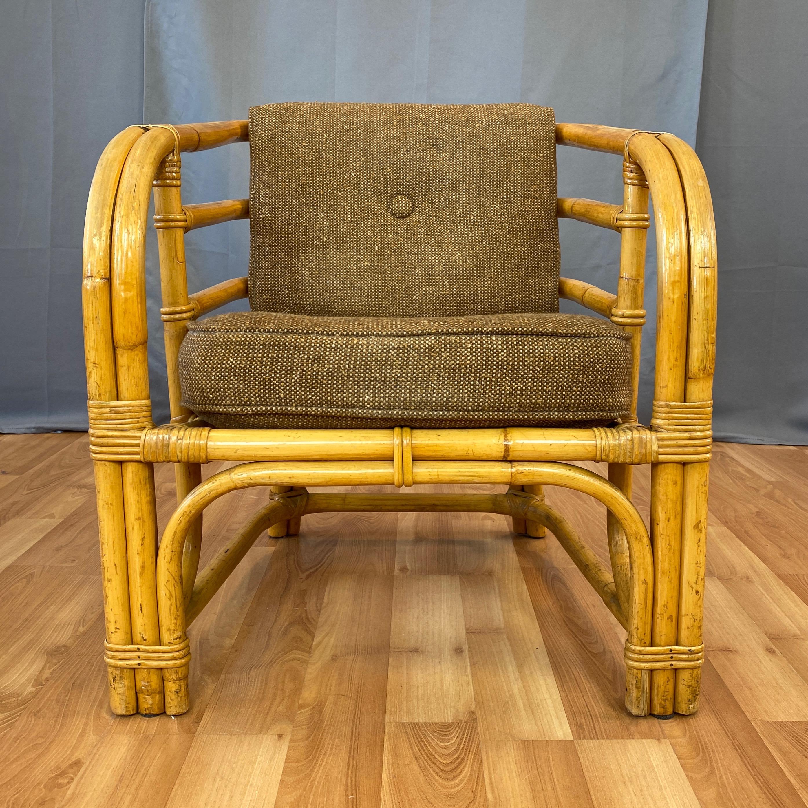 A very handsome mid-century rattan armchair with original cushions by Tropical Sun Co. of Pasadena, California.

Expertly-crafted bent rattan design features two-strand front legs that smoothly transition into comfortably curved arms and back.