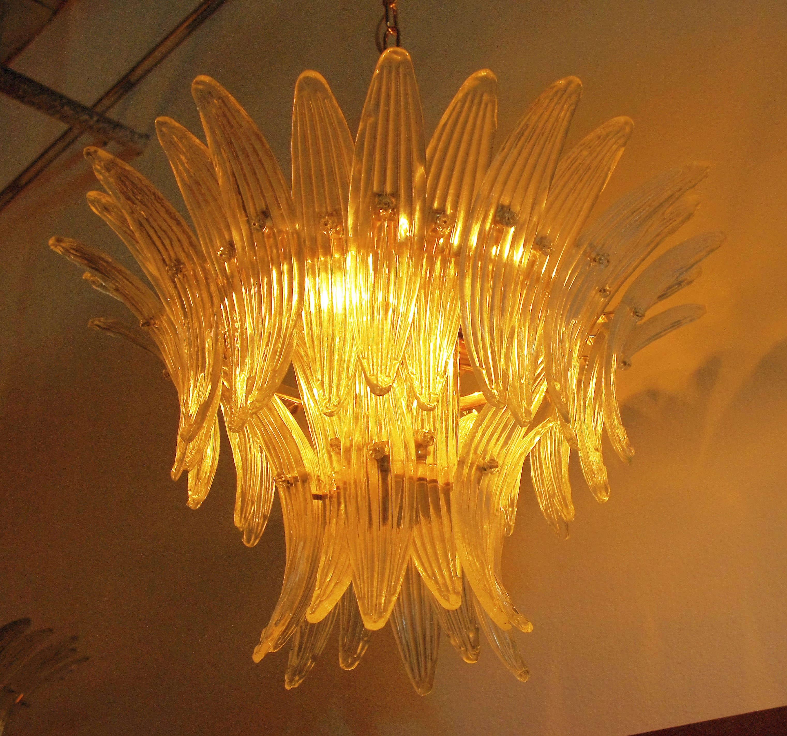 Italian Palmette chandelier with clear Murano glass leaves mounted on 24-karat gold plated metal finish / Made in Italy
6 lights / E26 or E27 type / max 60W each
Diameter: 25 inches / Height: 16 inches plus chain and canopy
Order only / This item