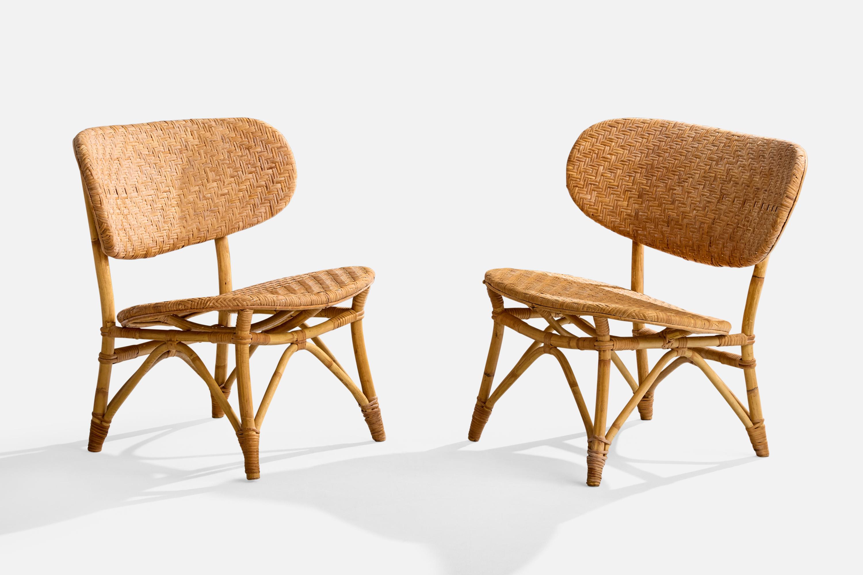 A pair of bamboo and rattan slipper lounge chairs produced by Tropikmöbler Ransta, Sweden, c. 1950s.

Overall Dimensions (inches): 27.25