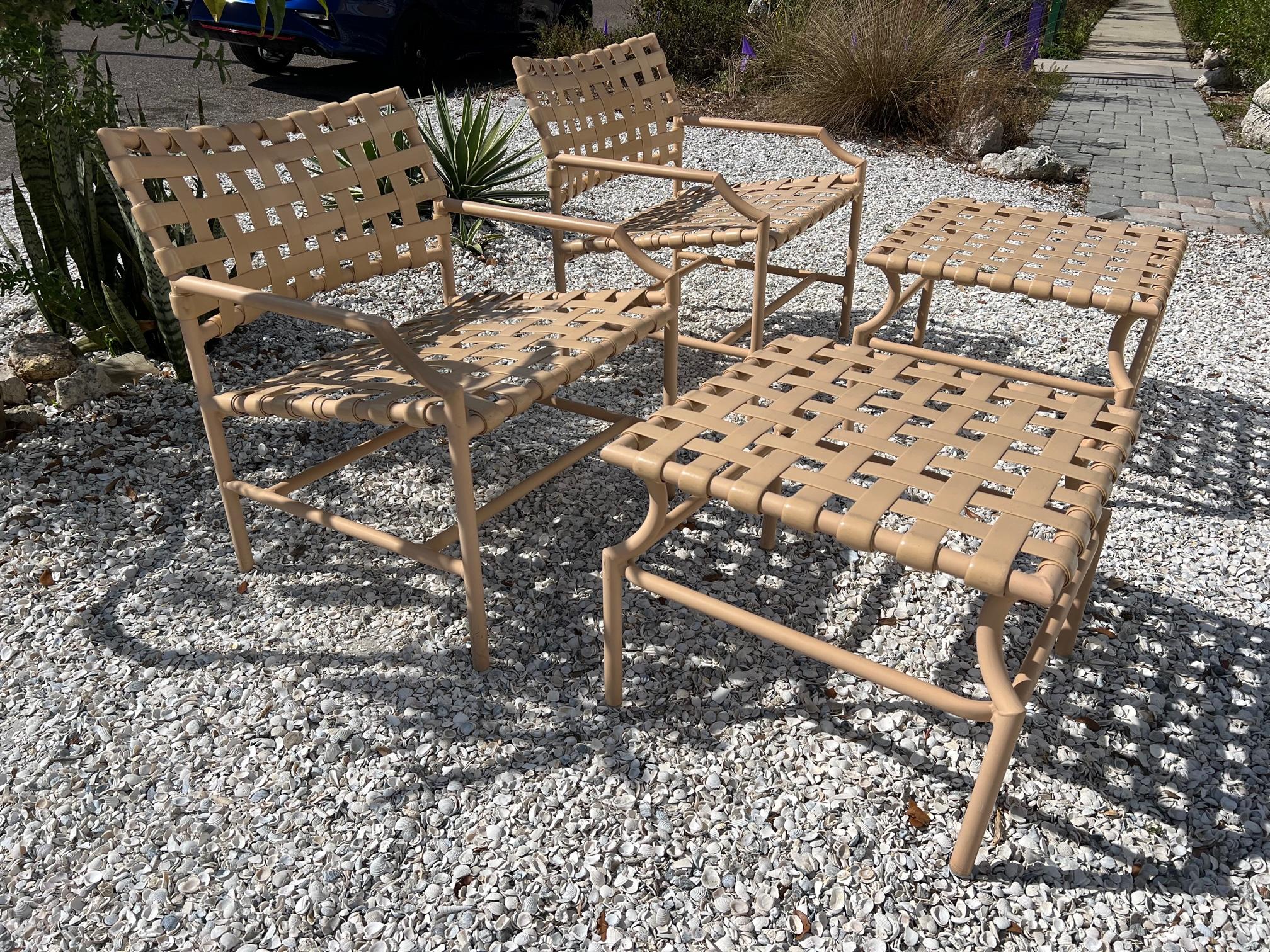 A clean outdoor set by Tropitone, Ca. consisting of a pair of lounge chairs with ottomans and a matching side table. Very good original condition, original paint and matching rubber straps-all tight and ready to use. A total of five pieces. Chairs