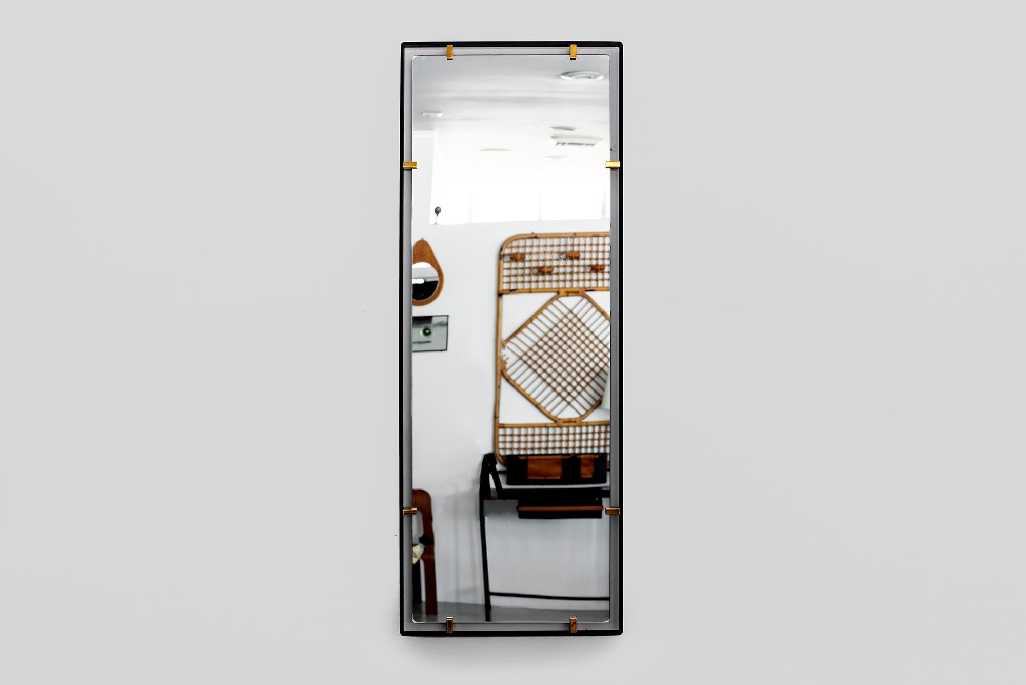 Iron frame and polished brass clasps support a floating rectangular mirror. 
Modeled after a vintage Italian design, newly produced at orange. 
Customizable sizes and finishes available.

Measures: 18