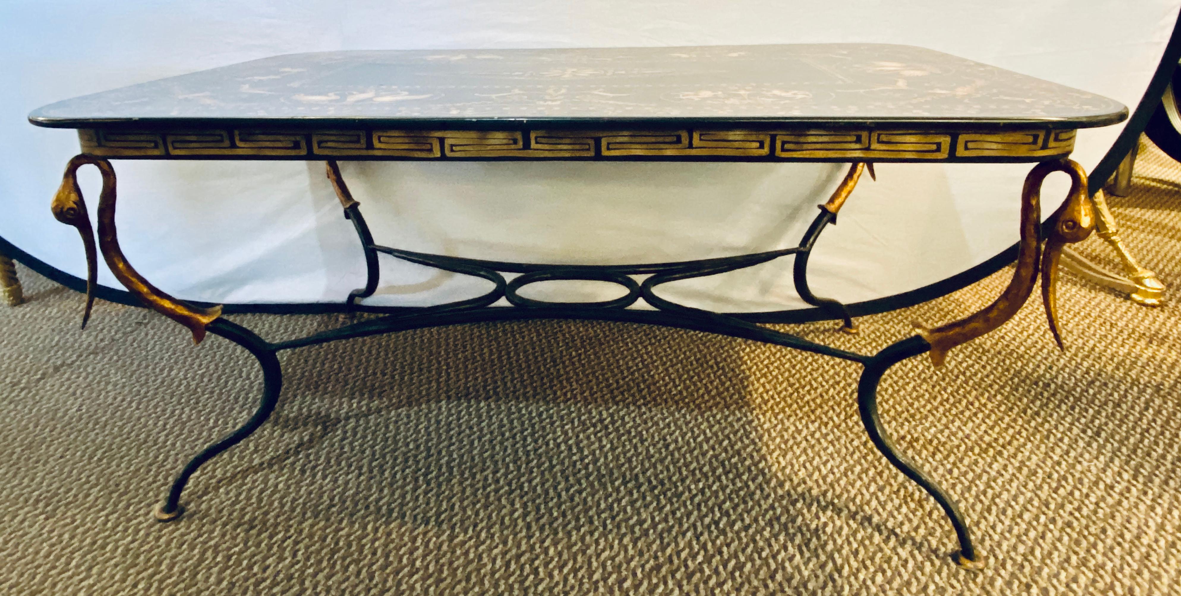 Trouvailles coffee table with toile paint decorated top on a gilt metal base and corner stork heads
EXA.