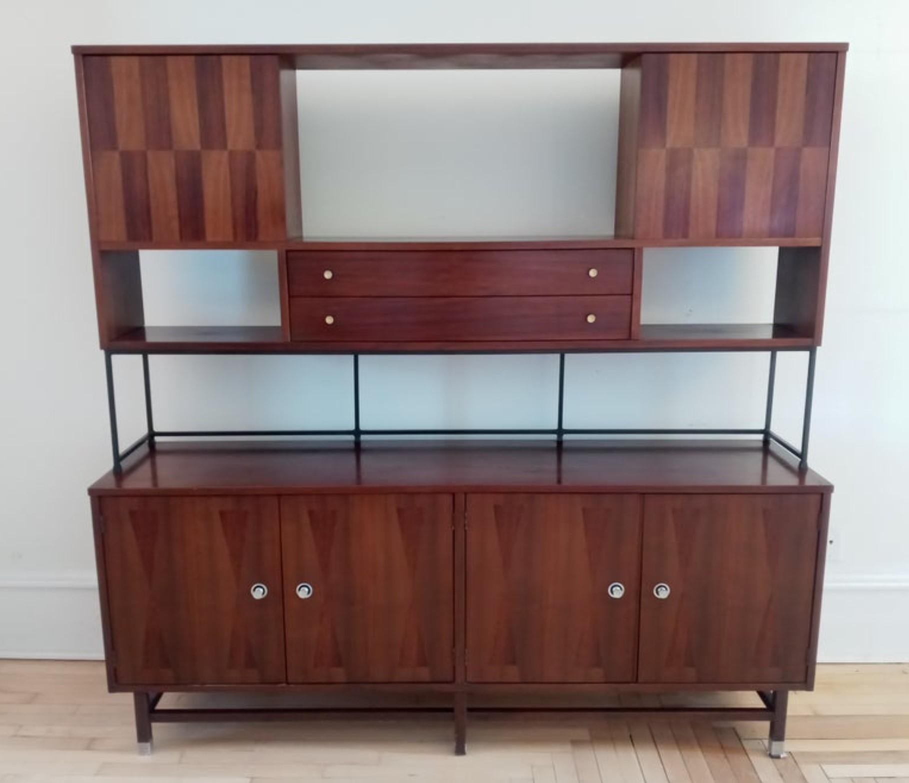 This is a superb Mid-Century Modern credenza or sideboard by Stanley. It is mostly walnut with geometric rosewood inlays on the fronts and has turned aluminum pulls. The lower cabinet has one shelf on the left and three drawers on the right, the top