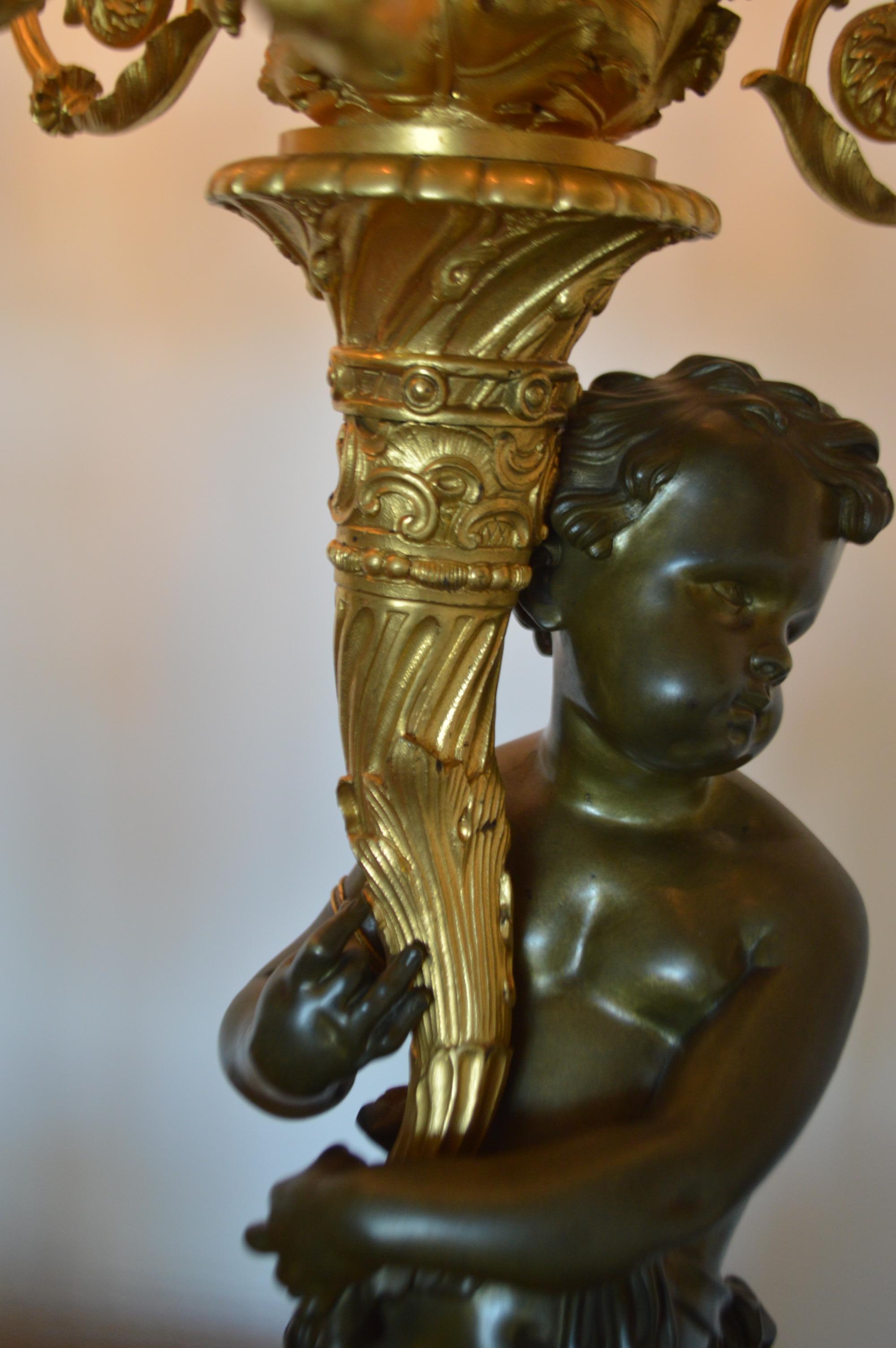 French True Pair of electrified gilded bronze candelabras, 7 lights, male, female putti For Sale