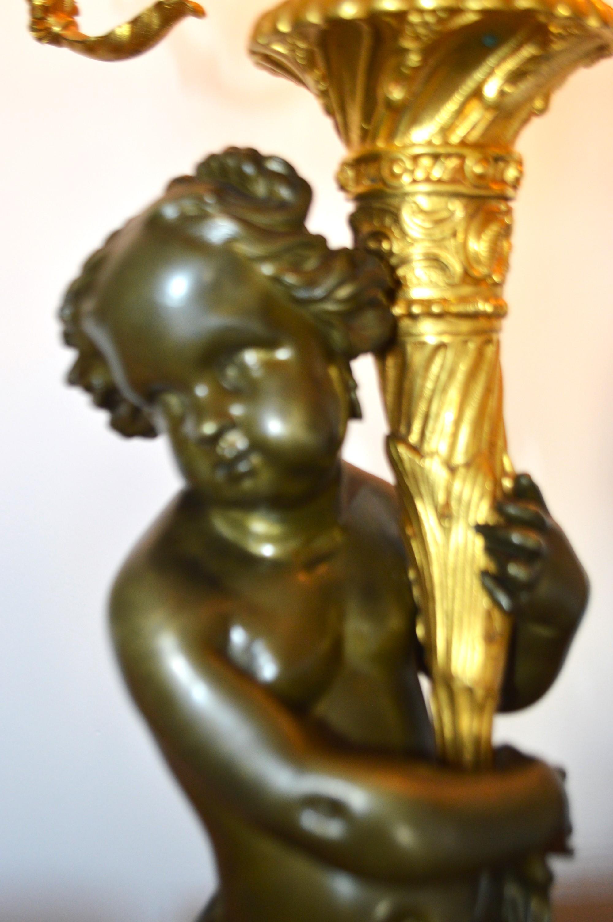Gilt True Pair of electrified gilded bronze candelabras, 7 lights, male, female putti For Sale