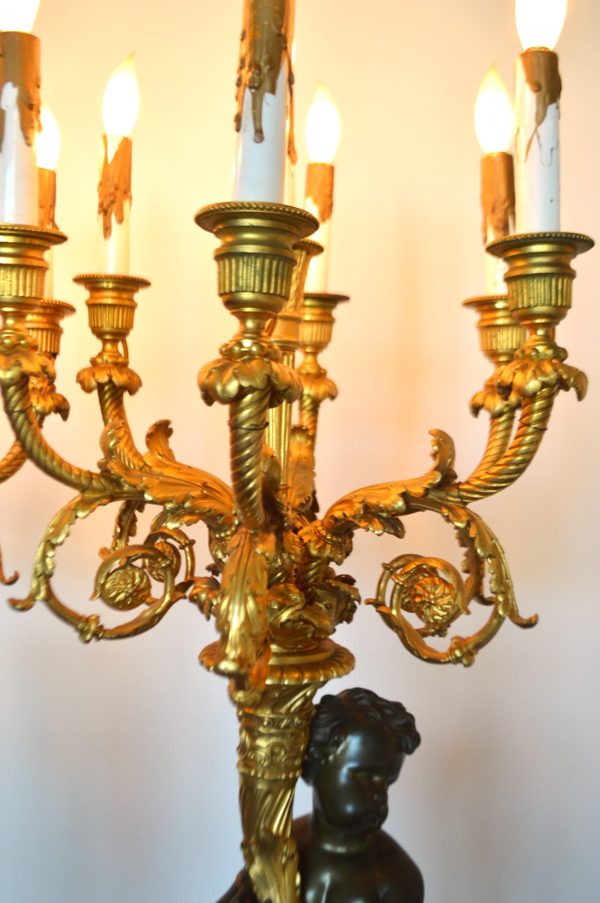 True Pair of electrified gilded bronze candelabras, 7 lights, male, female putti For Sale 1