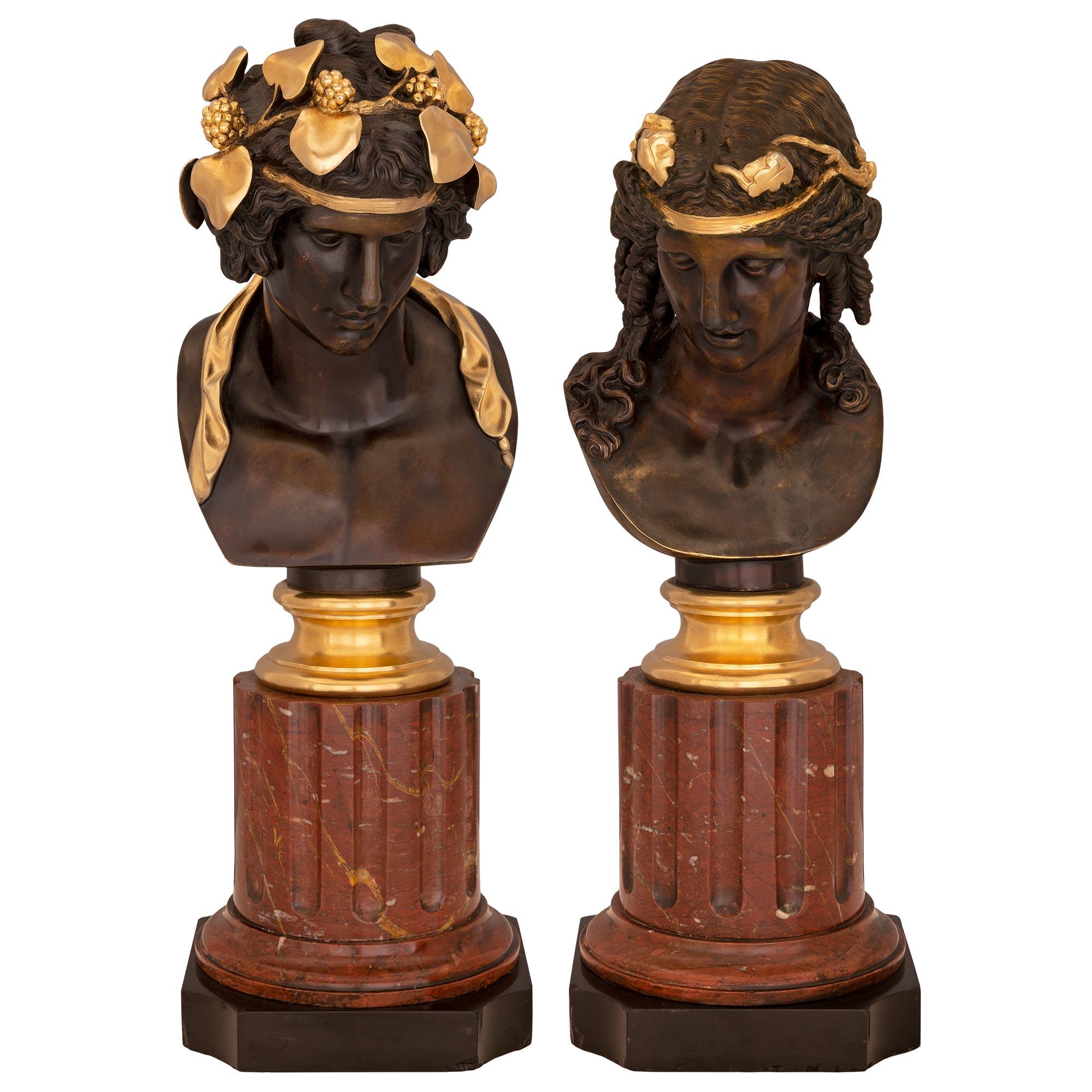 A striking and high quality true pair of French 19th century Louis XVI st. Belle Époque period patinated bronze, ormolu, Rouge Griotte, and black Belgian marble busts attributed to Ferdinand Barbedienne. The busts depict the Greek god Bacchus to the