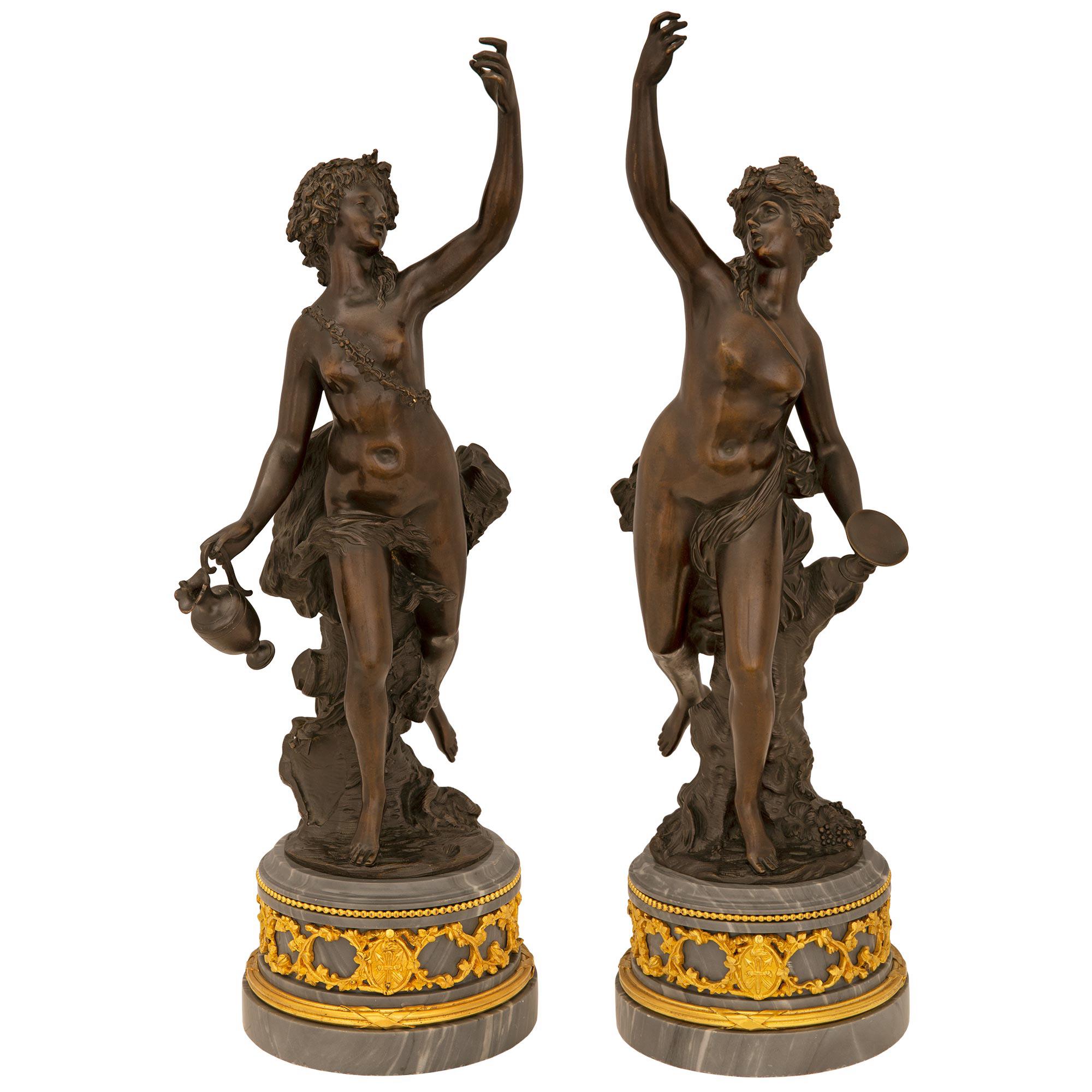 A beautiful and most elegant true pair of French, 19th century Louis XVI St, patinated bronze, ormolu and Gris St. Anne marble statues. Each statue is raised by a striking circular Gris St. Anne marble base with a fine wrap around tied fluted band,