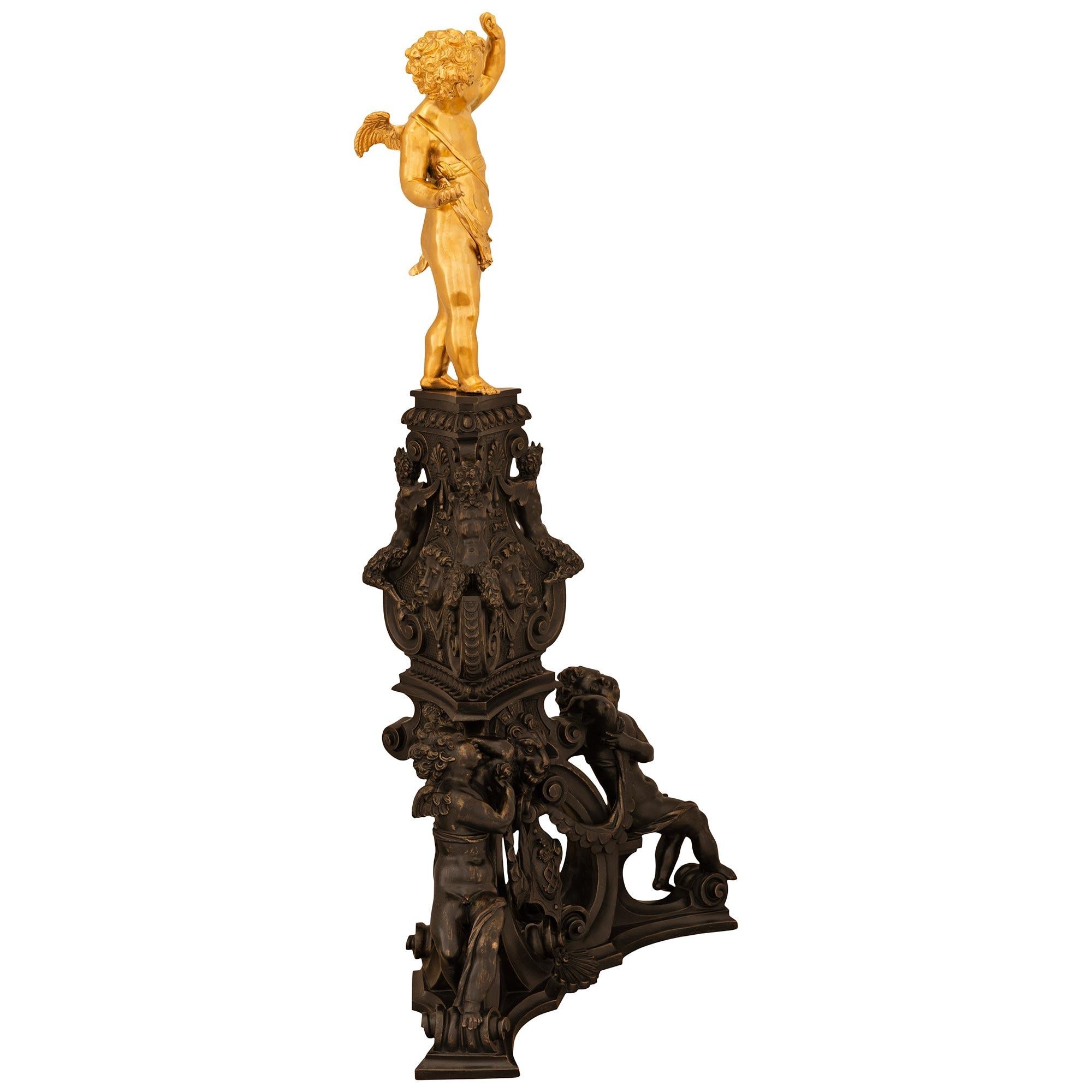 An exquisite and monumental true pair of French 19th century Napoleon III Period Renaissance st. Ormolu and patinated Bronze andirons, stamped by F. Barbedienne. Each andiron has an impressive large scaled base decorated with cherubs at the bottom