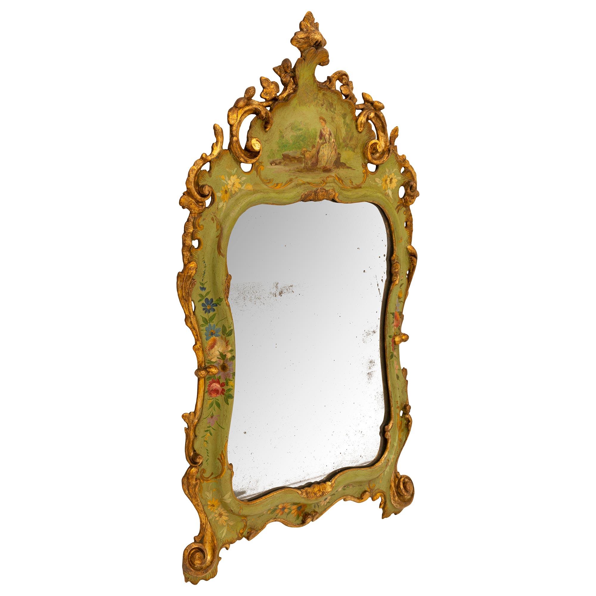 A charming and most decorative true pair of Italian 19th century Venetian st. patinated wood mirrors. Each small mirror retains their original mirror plates framed within an elegant scalloped gilt border with lovely finely detailed hand painted