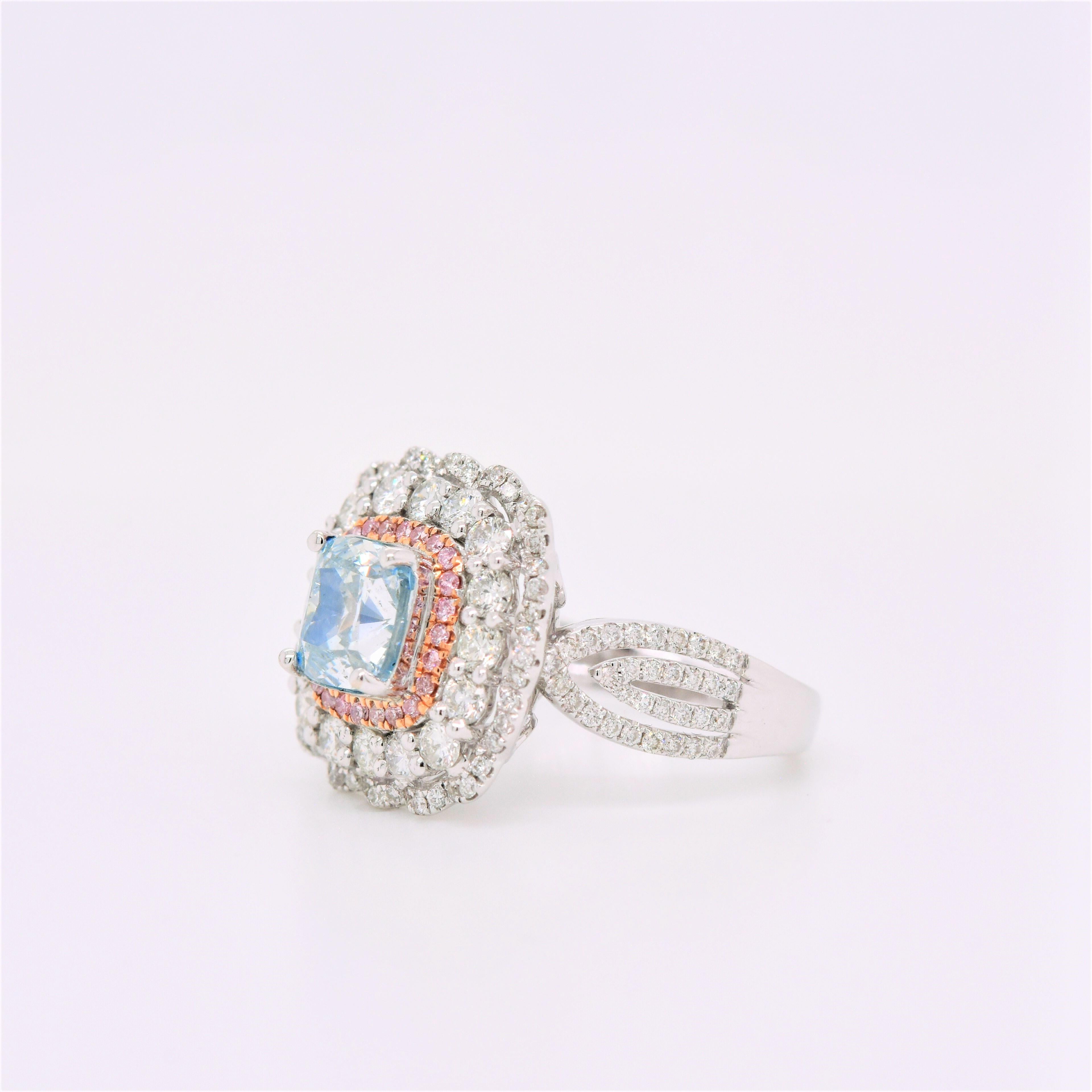 This engagement ring setting features a triple pave diamond white and rose gold halo surrounding the center Natural Fancy Blue Diamond, accented by a pave of Natural Fancy Pink Diamond stones around the center stone with open details. This setting