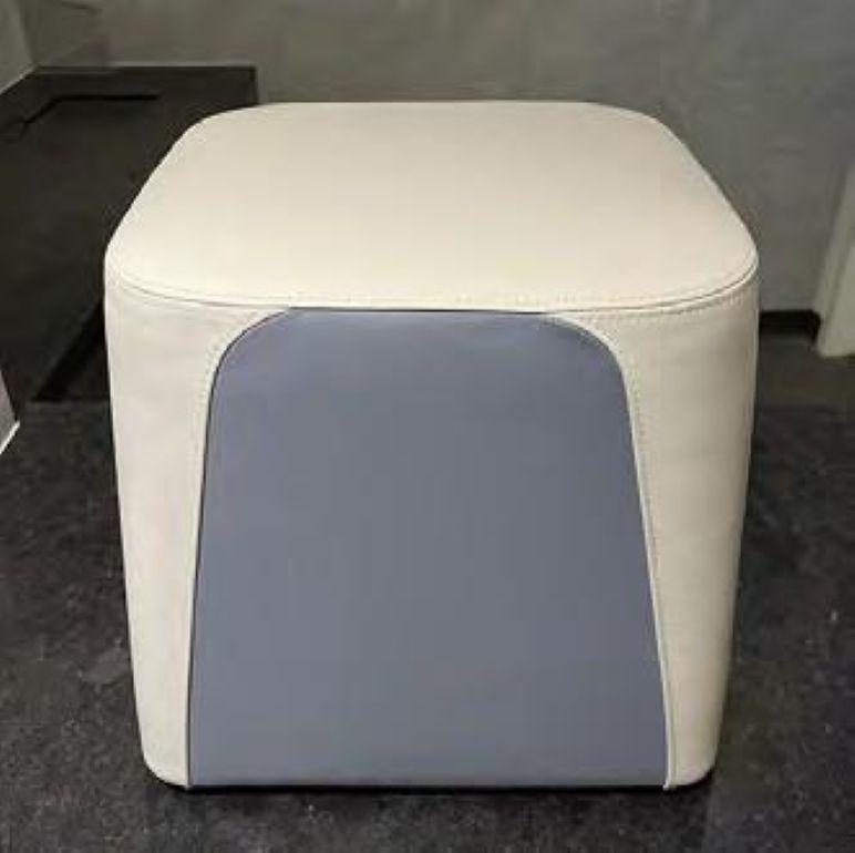 Defined by its soft, inviting shape and compact proportions, the Truffle Ottoman adds versatility and playful color, pattern and texture to rooms. Its body is upholstered in different materials that give it a two-tone graphic appeal, while its