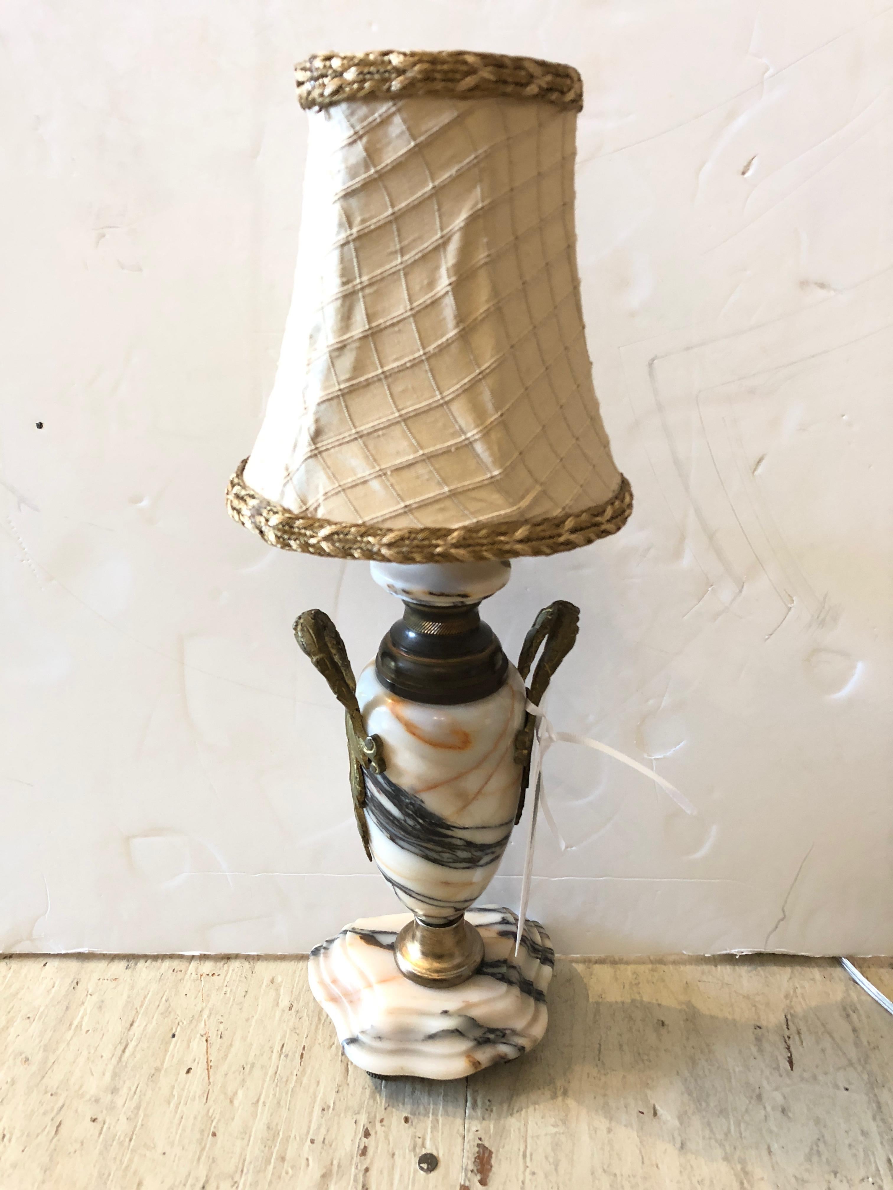 Pair of diminutive super refined Carrara marble and gilt metal decorated urns converted to electric lamps, newly rewired. Custom silk shades.