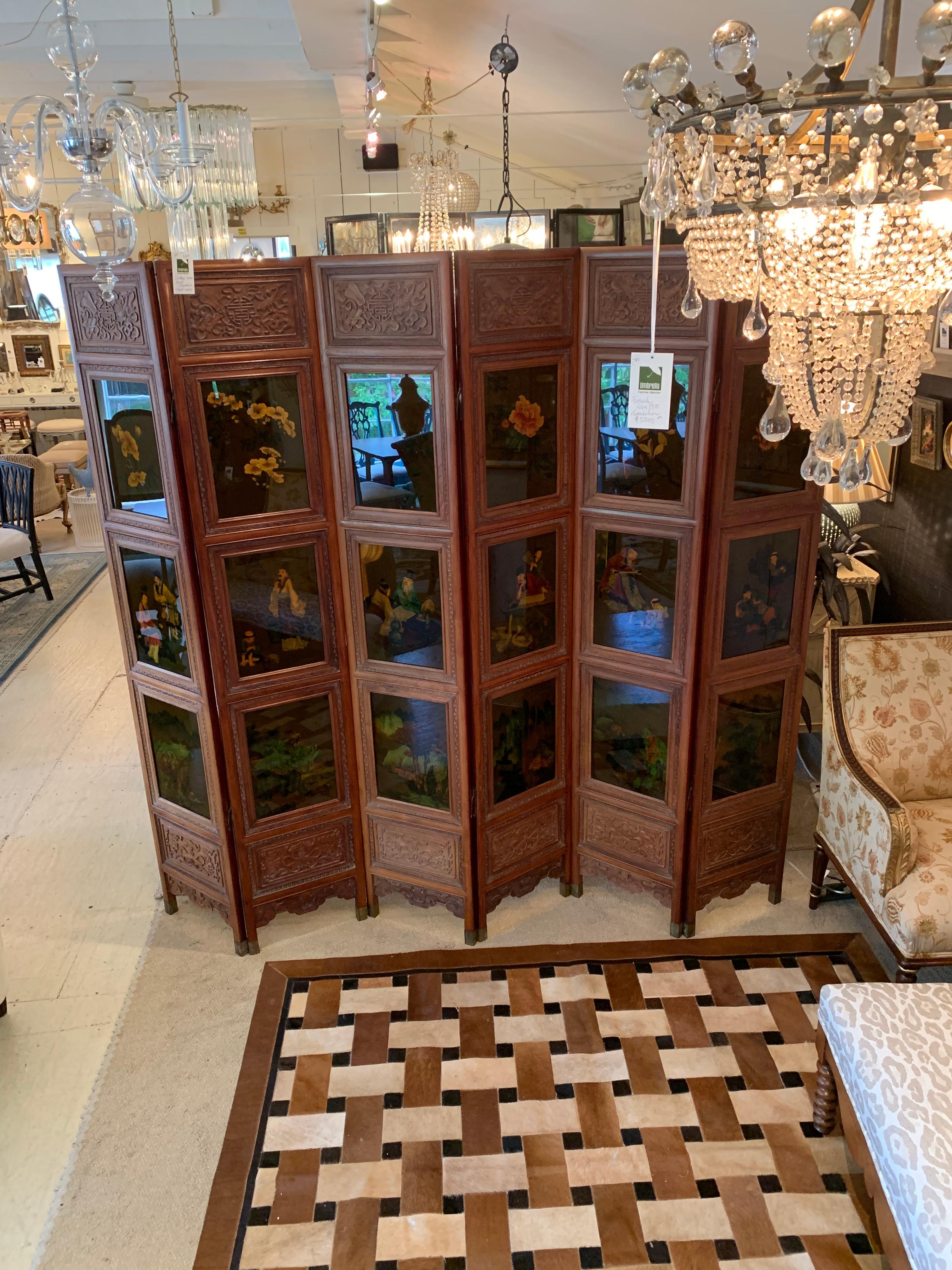 A rare find purchased in Hong Kong from an antiques dealer in the 1980s, this is a magnificent 6-panel intricately carved wood screen having 3 gorgeous reverse paintings on glass in each vertical panel. Some of the paintings are detailed renderings