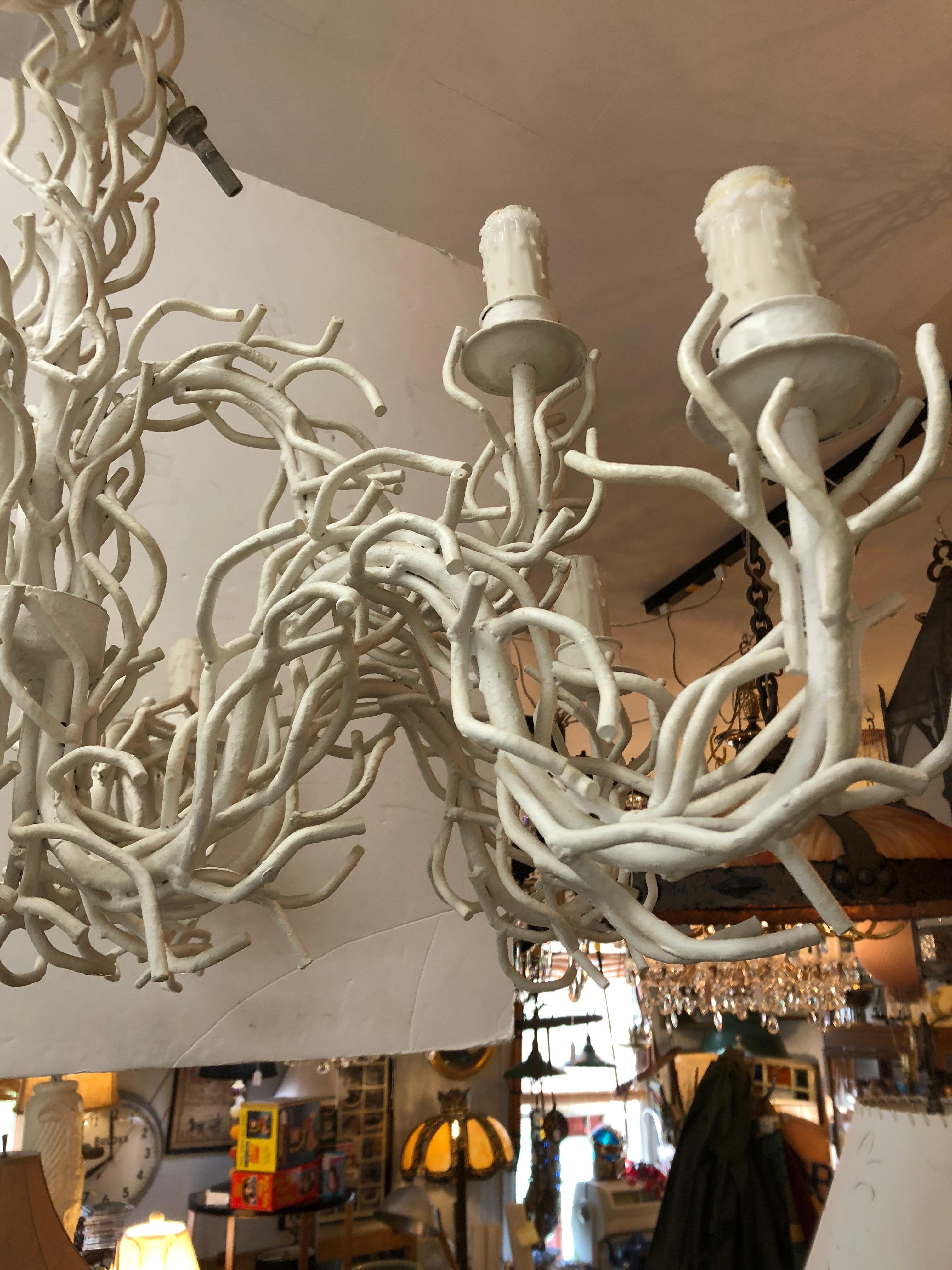 Very large focal point of a chandelier made of white painted iron to look like wonderfully interlaced tendrils of coral, having two tiers of lights, 3 on the top and 6 on the lower part.
Ample 2 feet of chain and original ceiling cap. White wax