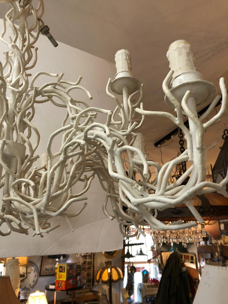 Very large focal point of a chandelier made of white painted iron to look like wonderfully interlaced tendrils of coral, having two tiers of lights, 3 on the top and 6 on the lower part.
Ample 2 feet of chain and original ceiling cap. White wax