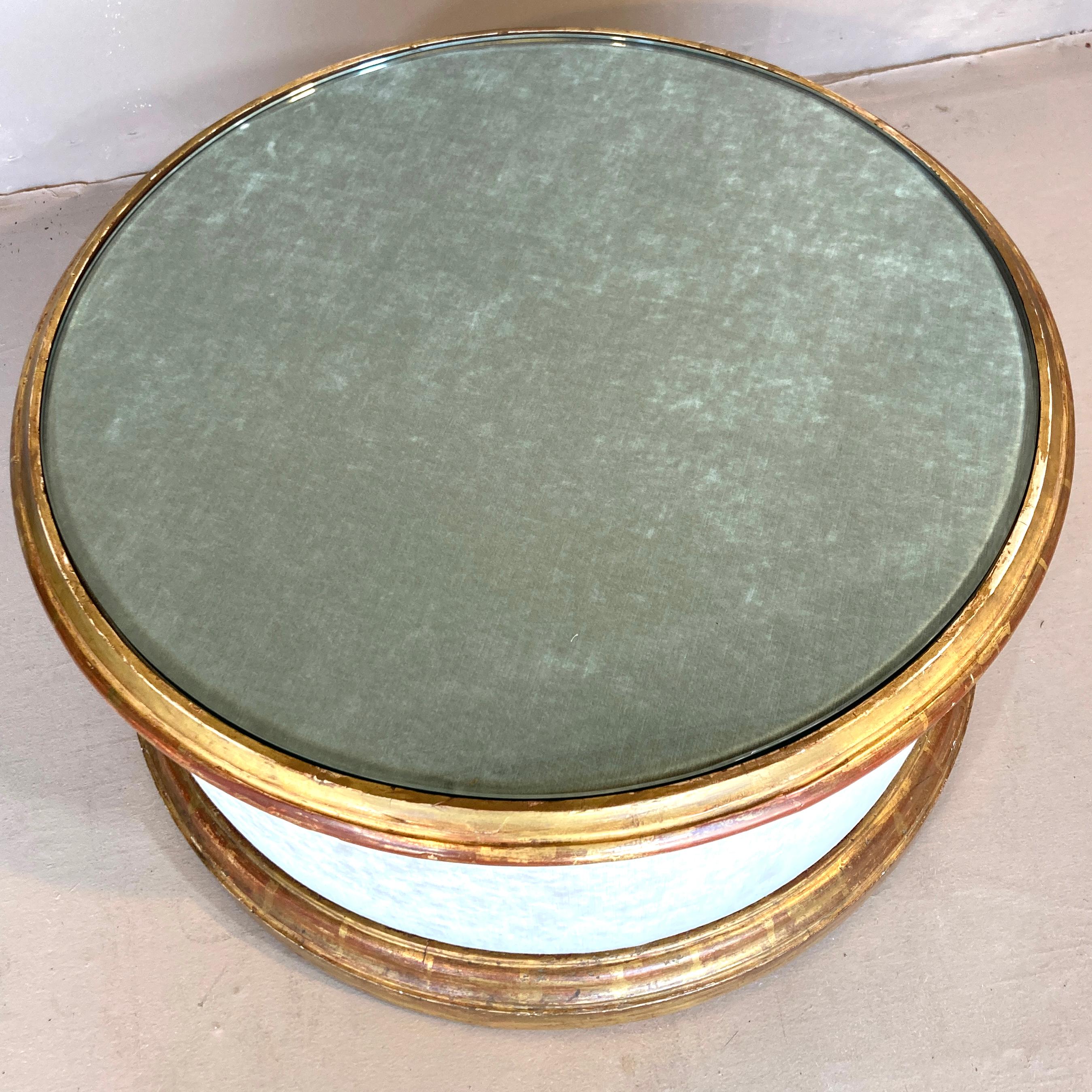 A truly unique 1940s coffee table, probably custom-built for a designer in the Philadelphia area. The molded and gilded rings are highly unusual - and they can be removed for a different fabric choice. The house-worn surface of the gilding is quite