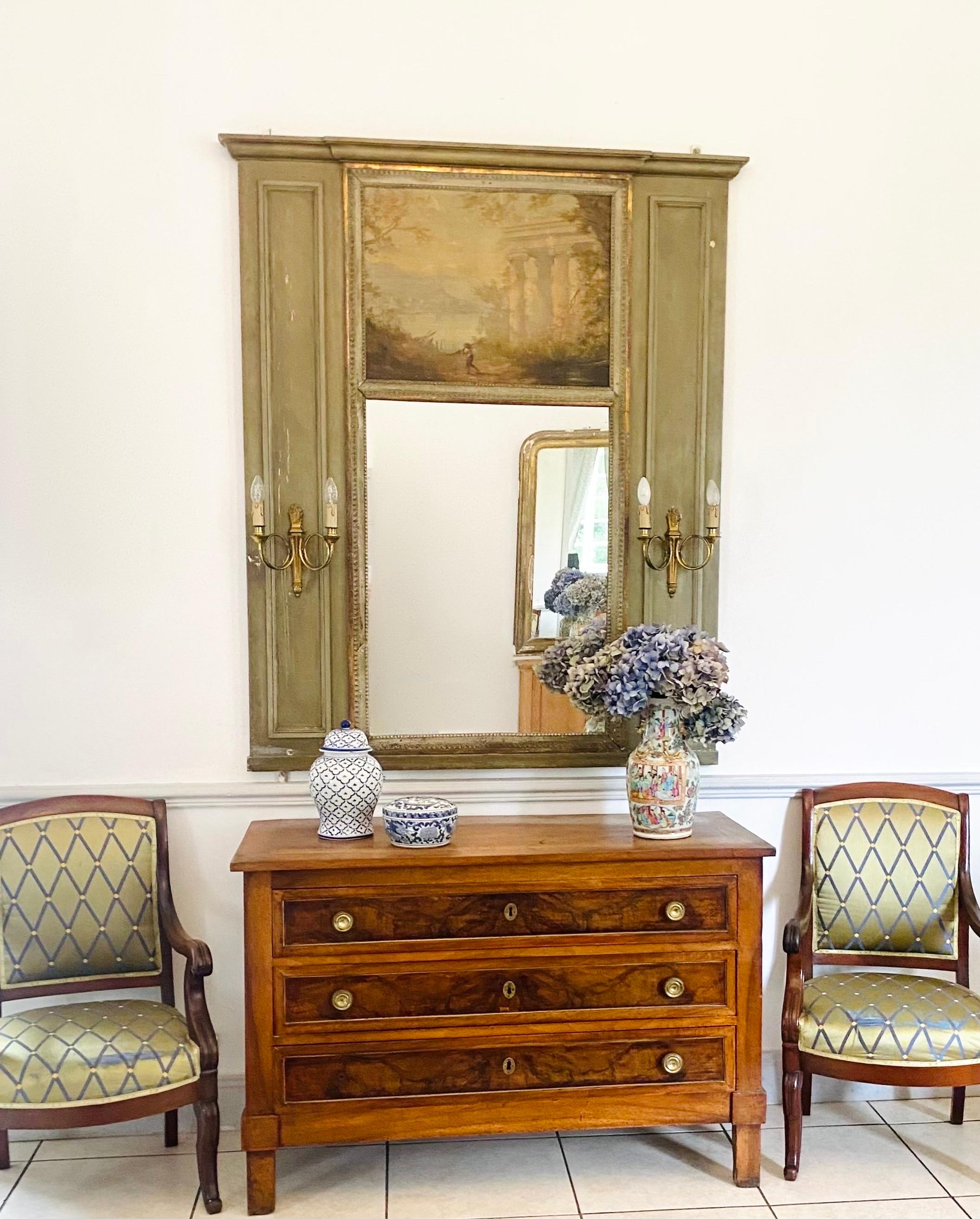 Magnificent Large trumeau mirror Dating from the 18th century Louis XVI period.
The trumeau is in Rechampi green and gilded lacquered wood.
It consists of an original mirror in the lower part and a very pretty oil on canvas in the upper part. On