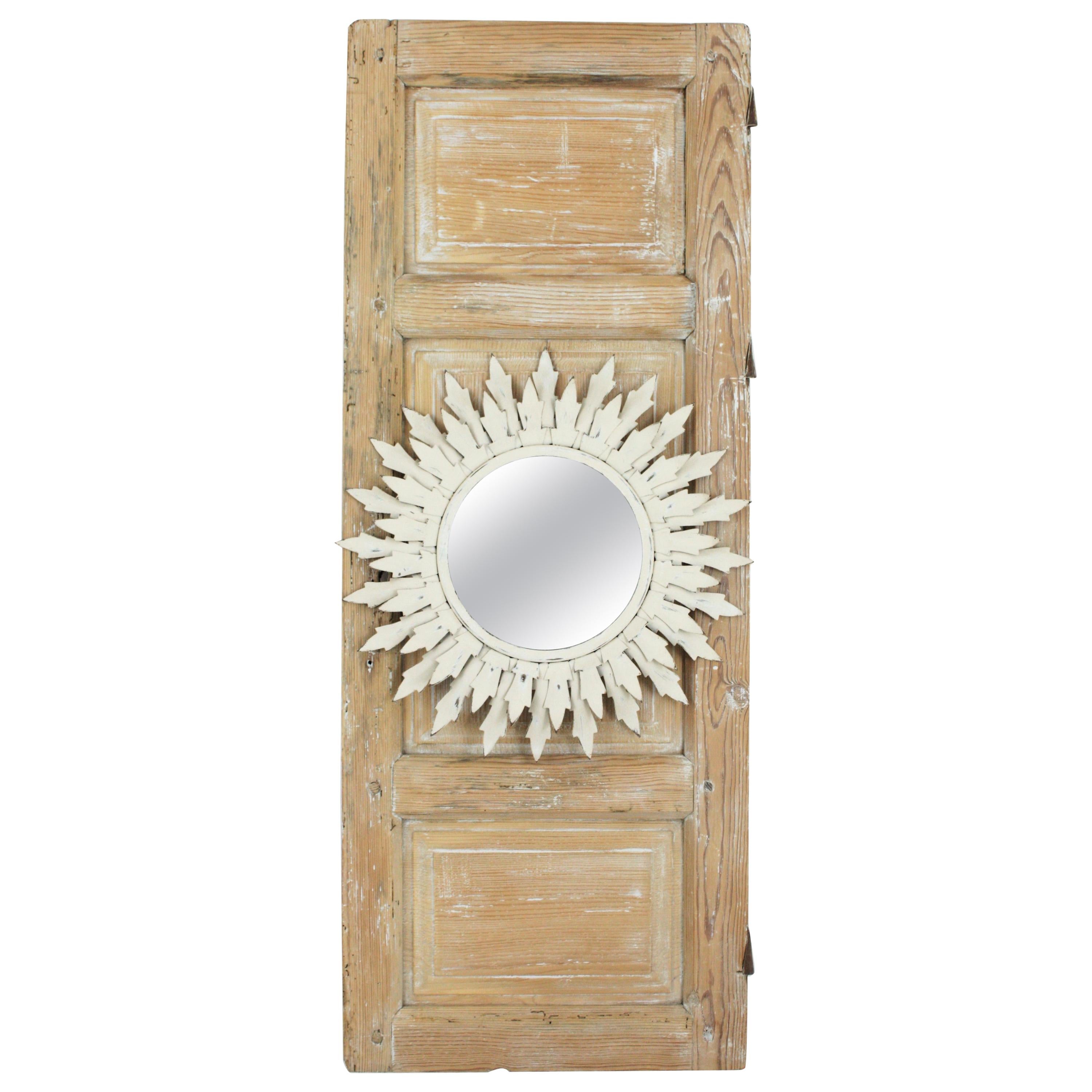 Spanish White Sunburst Mirror Framed by a Wood Patinated Door