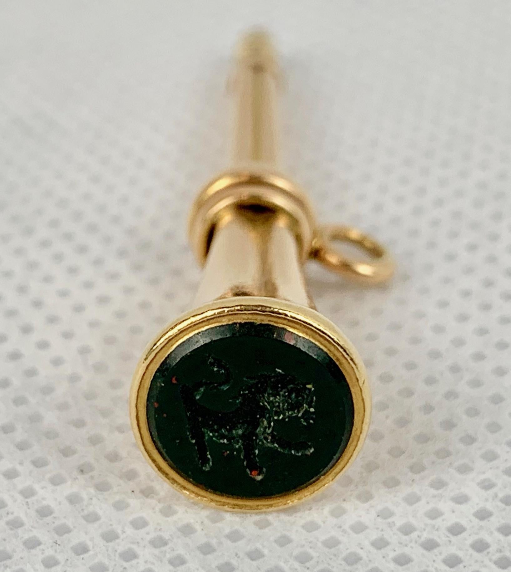 Nineteenth century 14k gold watch key fob in a trumpet form.  The simplicity of this form is prime.  A bloodstone intaglio of a rampant lion is placed at the wide end of the fob.  Bloodstone is the gem stone for March.
If not placed on a watch chain