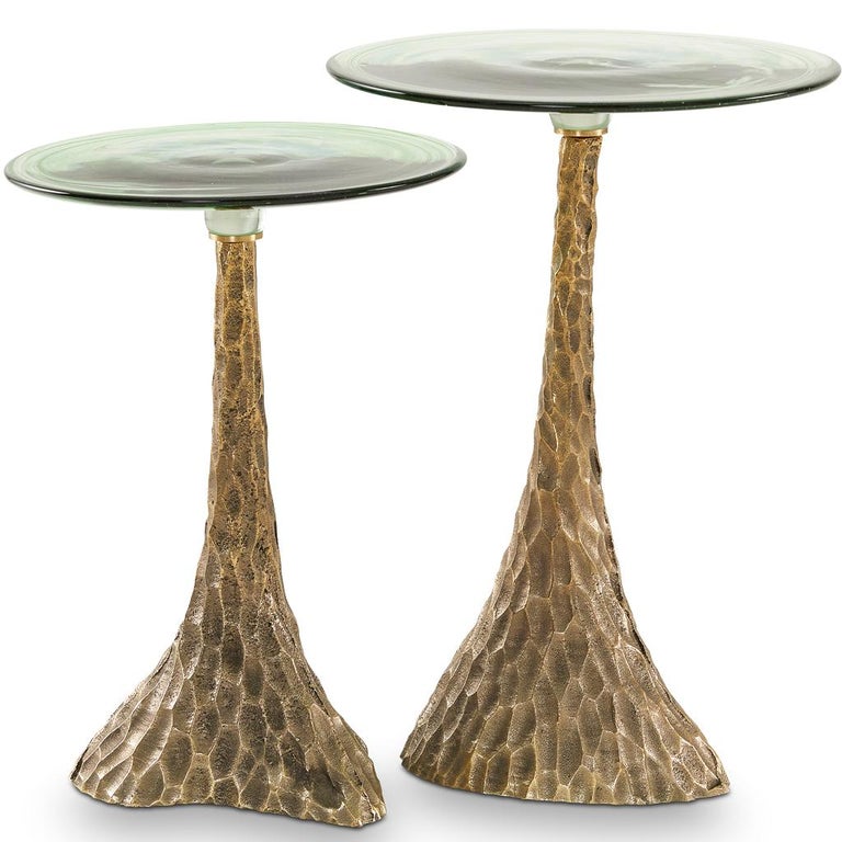The Trumpet nesting side table set is designed by Egg Designs and manufactured in South Africa. 

The Trumpet nesting side table set is entirely handmade. The base is solid chiselled sand cast brass, hand polished and paired with a handblown glass