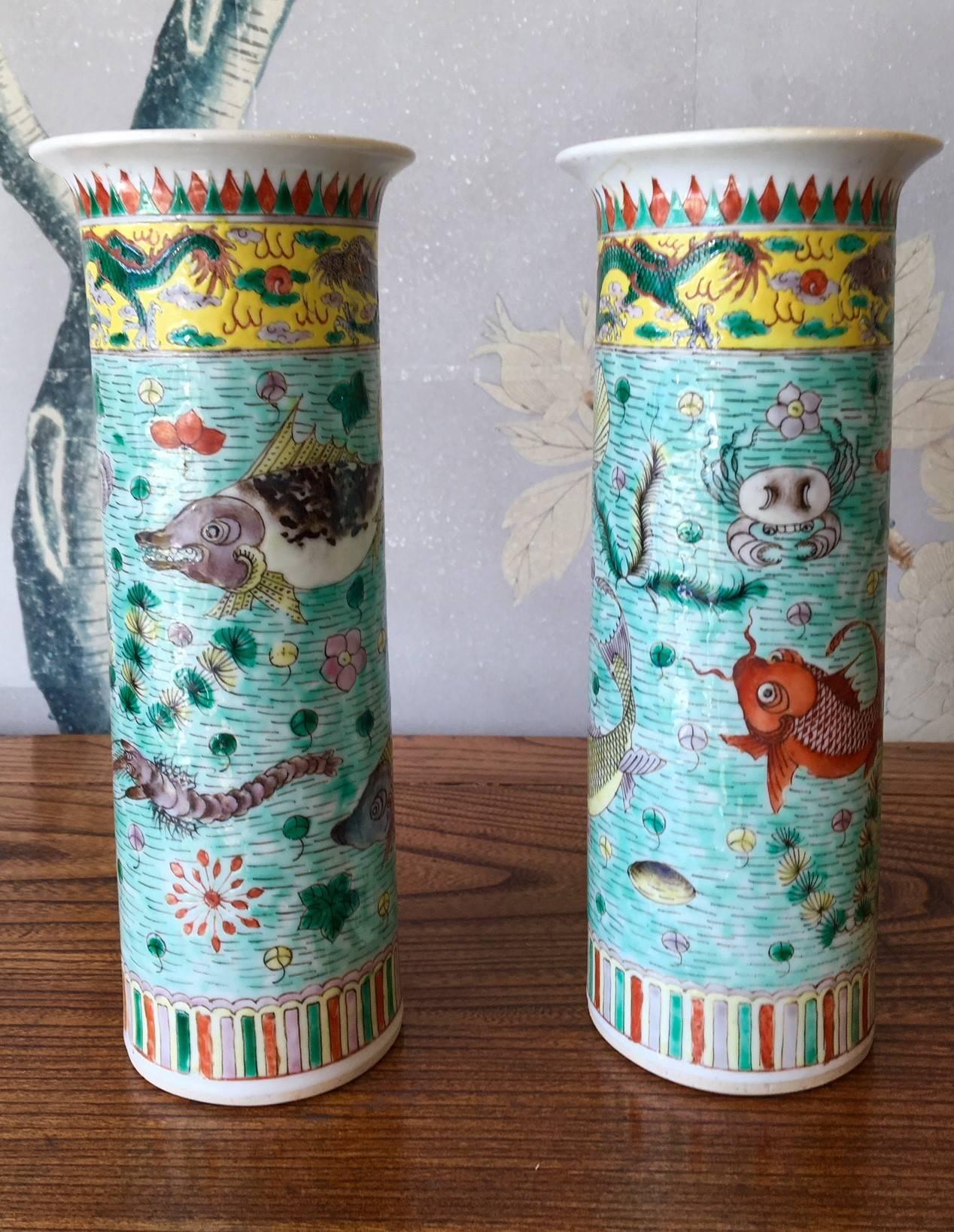 A pair of late 19th century famille verte trumpet shaped vases with design of shrimp, fish, and other sea life.