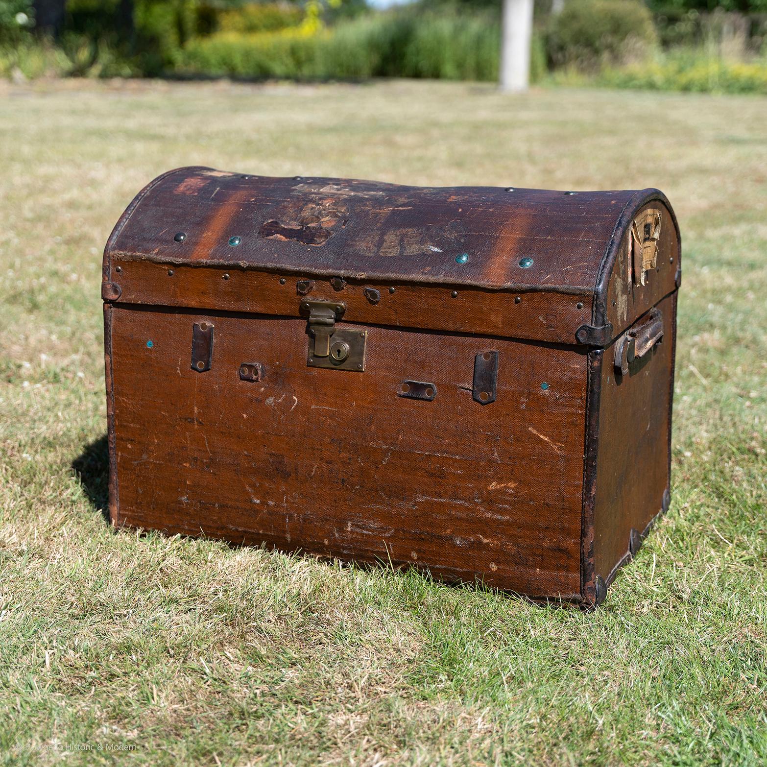 A characterful 19th century, domed, overseas, travelling, steamer, trunk in canvass with leather trim, handles and brass hardware with lock. No key. The exposed straps removed. Bearing an old Southern Railway paper label no 2812 from Dover Priory