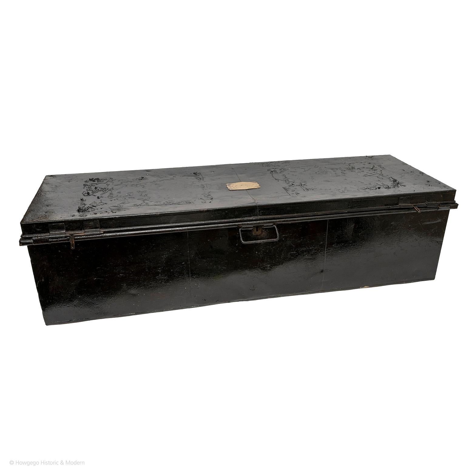 Long black metal trunk, bearing brass label inscribed 'J E Holmes Esq, Volunteer Artillery'. Metal carrying handles. Locks no keys. Wonderful deep and rich patina reflecting their history from years of travel

Can be repurposed as a chests on stands